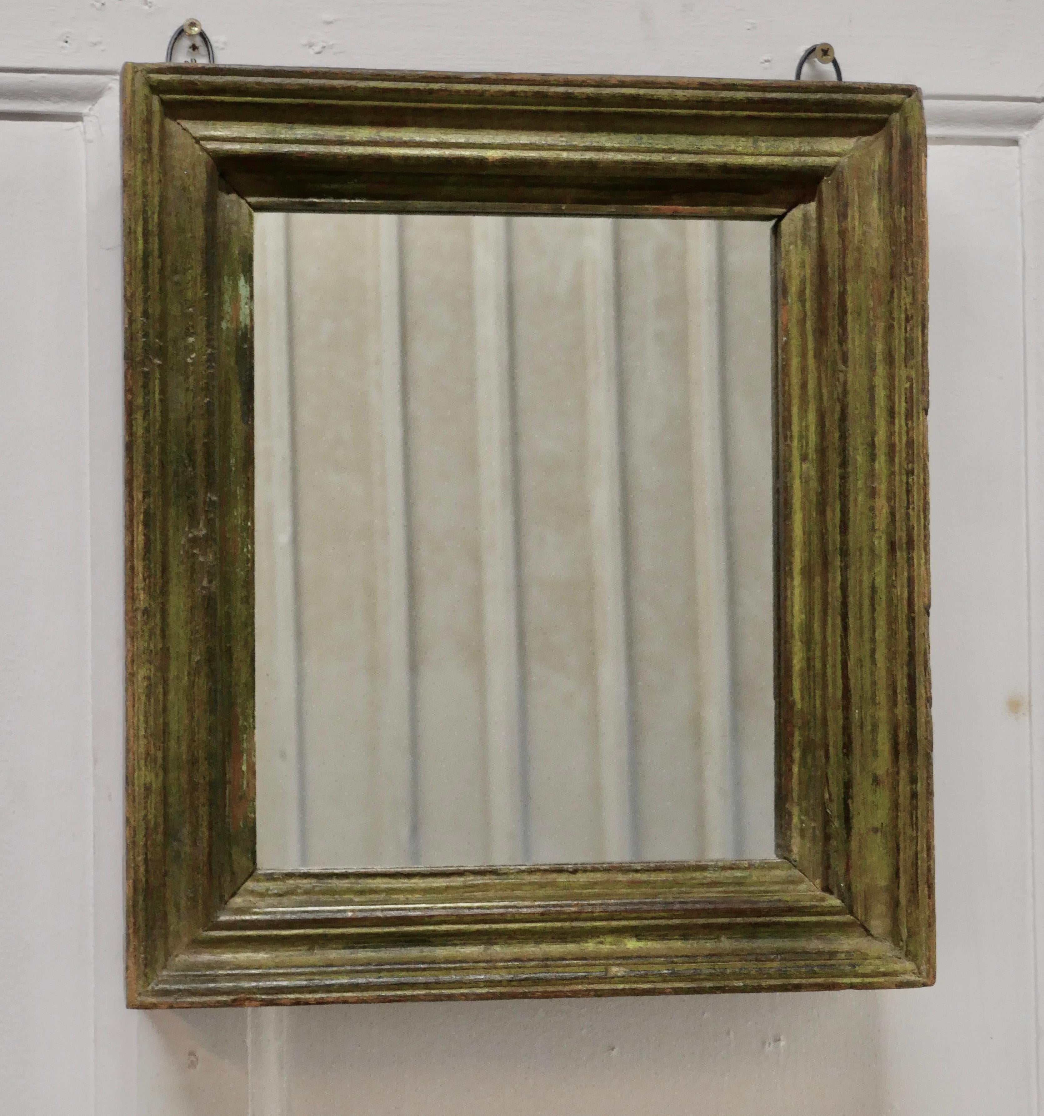 19th century French wall mirror with an old painted frame

The mirror has a simple moulded 2.5” wide wooden frame with old shabby green paint
The glass is in good condition and seems to be have been replaced at some time
A good attractive piece