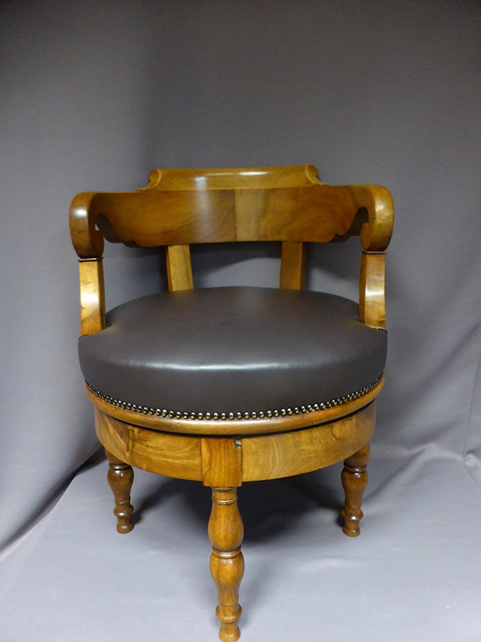 19th century French walnut office turning armchair. 
The seat is covered with a chocolate full grain leather.
Very nice quality.
 