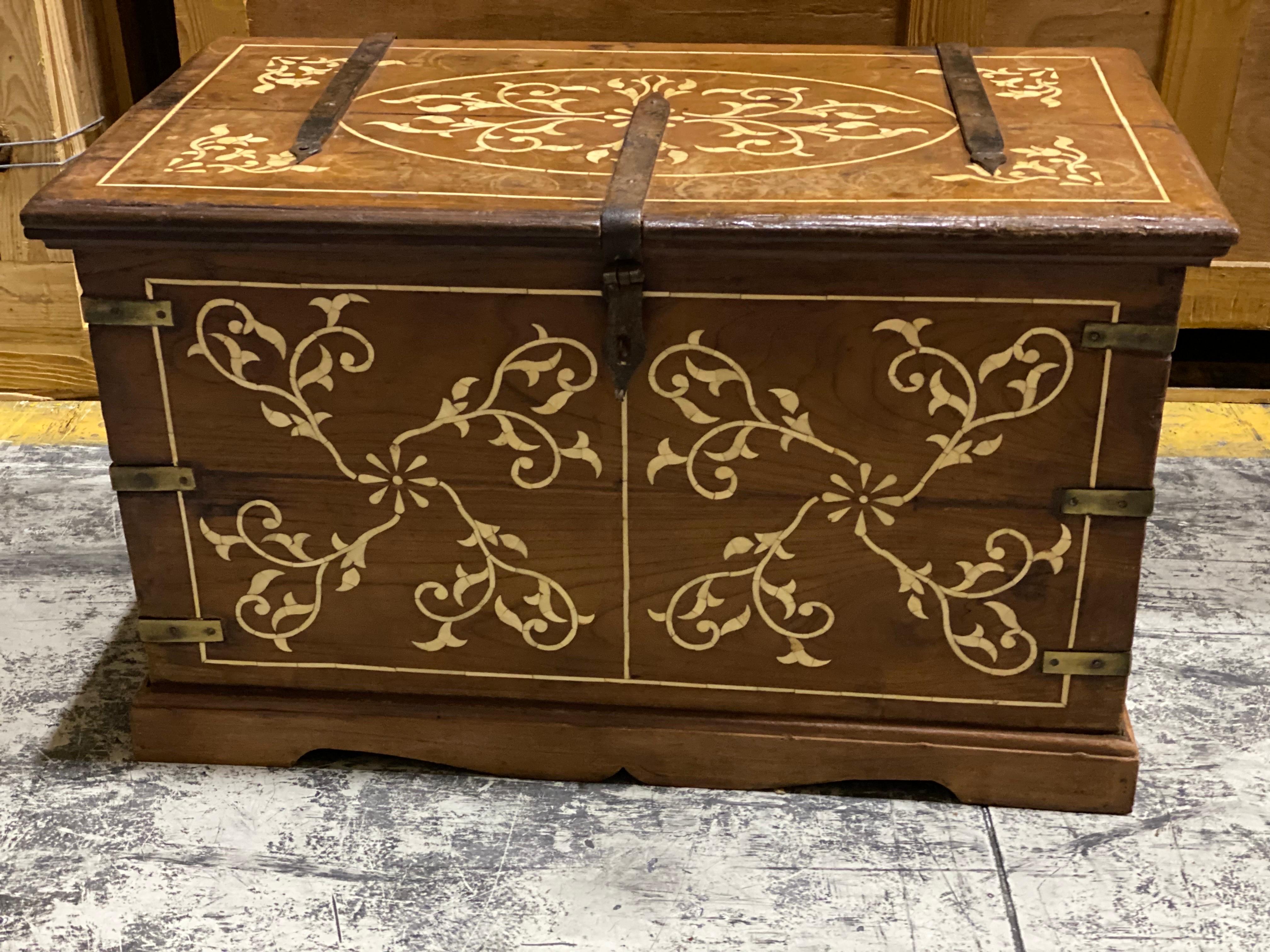 19th Century French walnut & bone floral inlaid trunk.
A smaller size trunk with beautiful floral inlaid bone design on the top, front and sides. The back left plain. Brass hardware looks original cut into the wood. The top wrought iron straps look