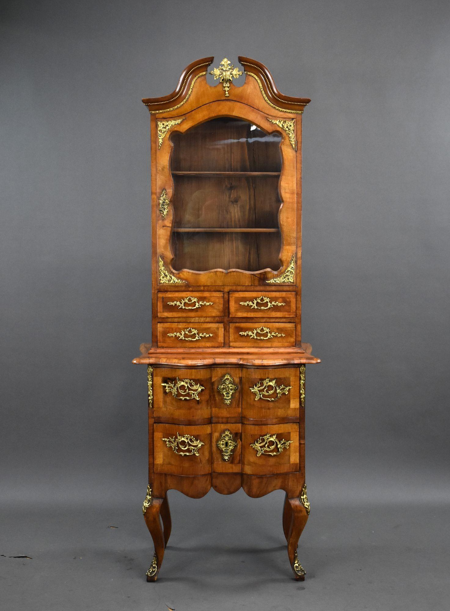 A beautifully crafted 19th-century French Bonheur du Jour (lady’s writing desk), showcasing classic Louis XV-inspired design. Made from rich walnut, this elegant piece features an upper glazed cabinet with shaped glass and two interior shelves,