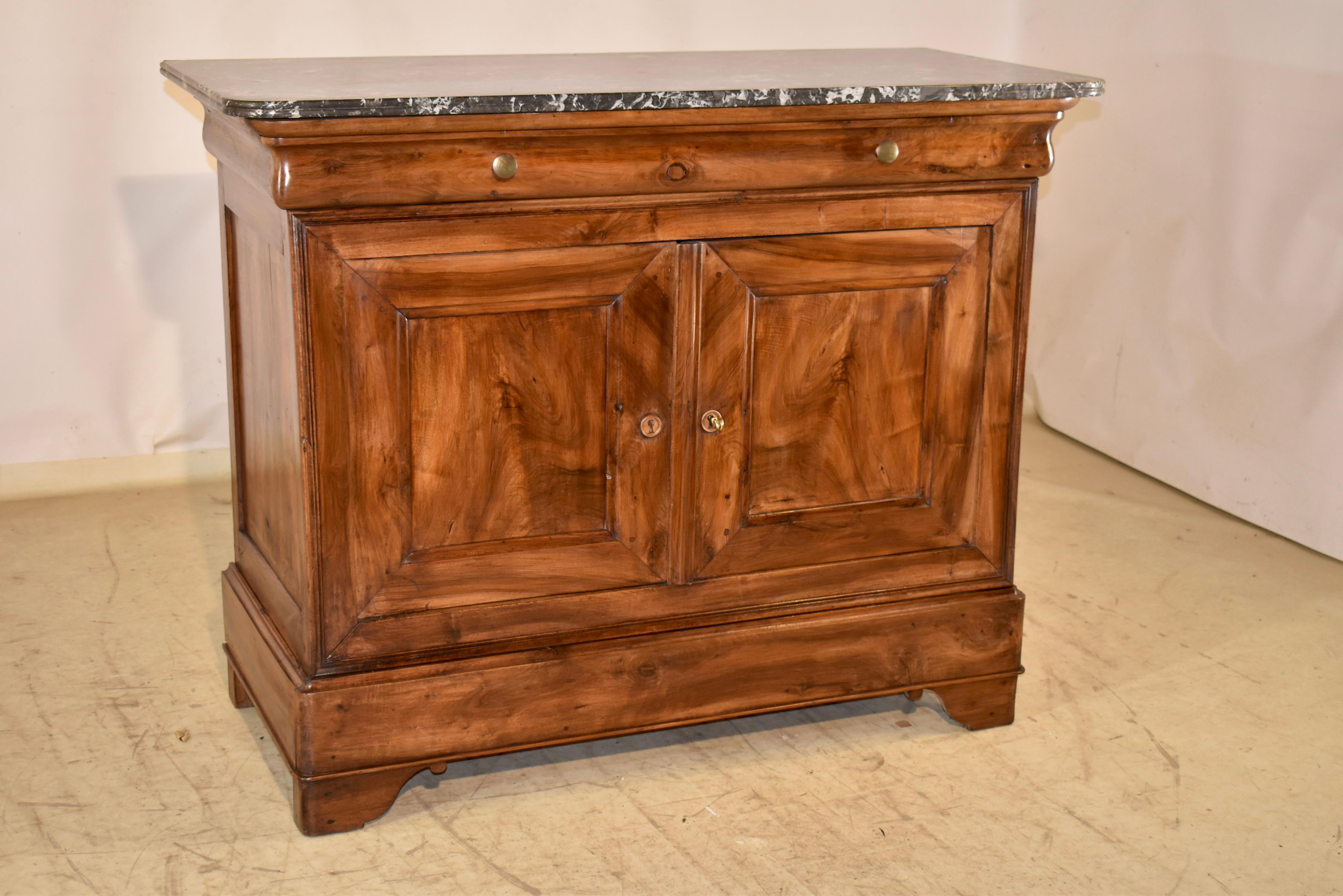 19th century period Louis Philippe buffet with a marble top.

This piece is absolutely stunning all around.  The top is cut from the most gorgeous black marble with exquisite matrix we have had the pleasure to offer.  This follows down to a show