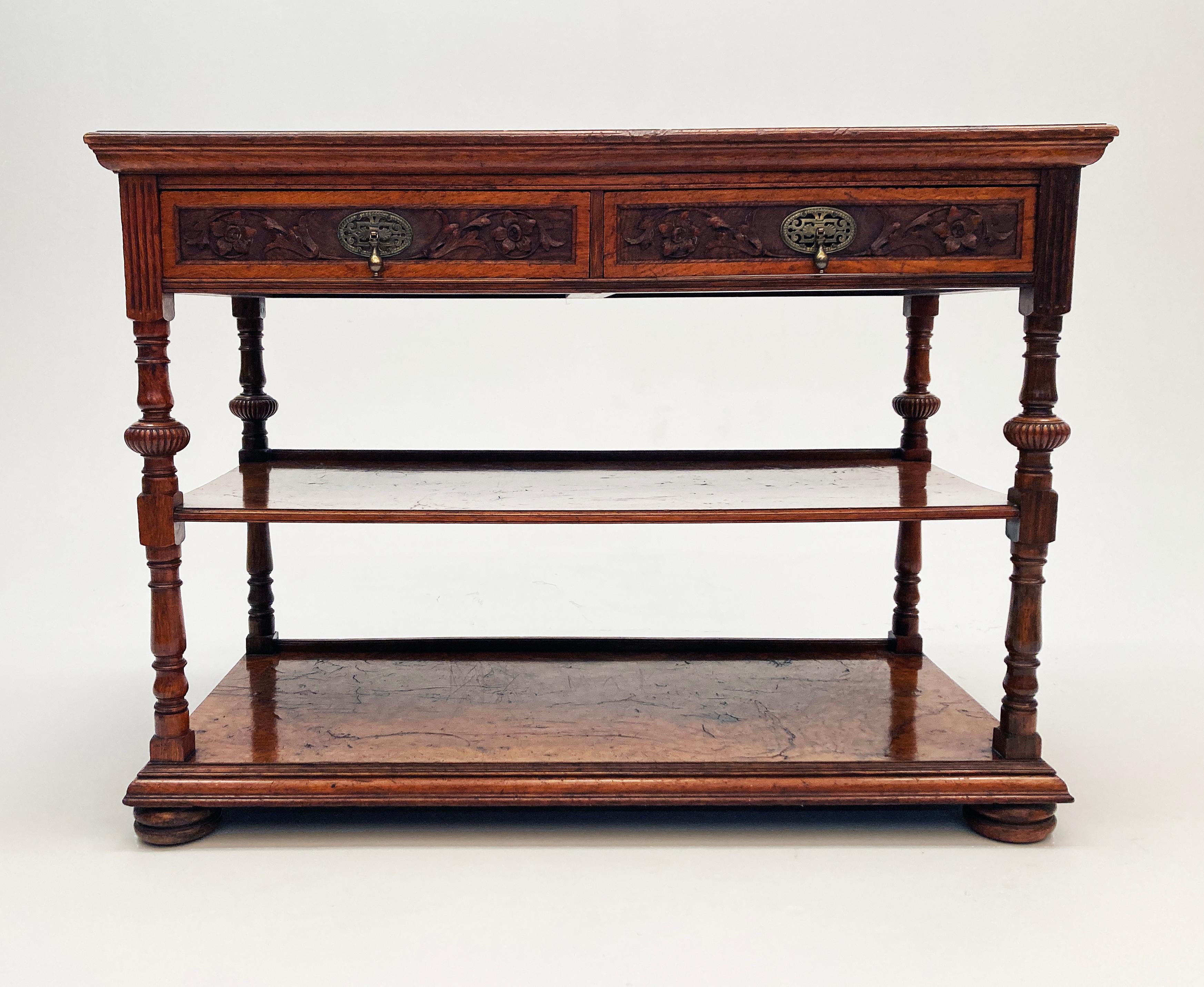 Stunning 19th Century French Burl Walnut Buffett with two panel drawers each with intricately carved floral motifs within the center panels, each drawer has brass hardware with ornate markings and a droplet pull handle. The piece boasts two lower