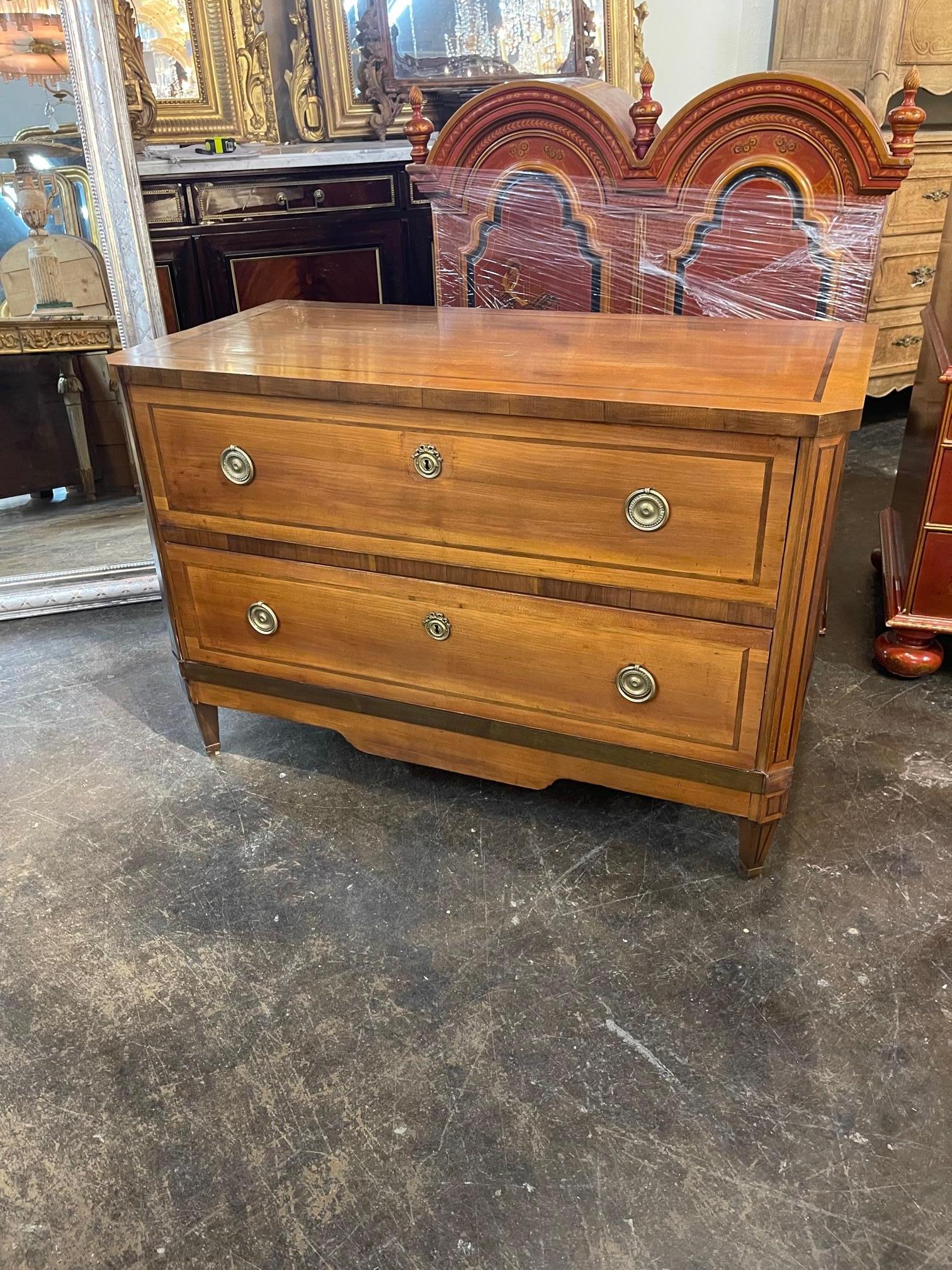 Handsome 19th century French Walnut commode. This piece has lovely clean lines and a very fine finish. Pretty hardware as well. Great for a variety of decors!