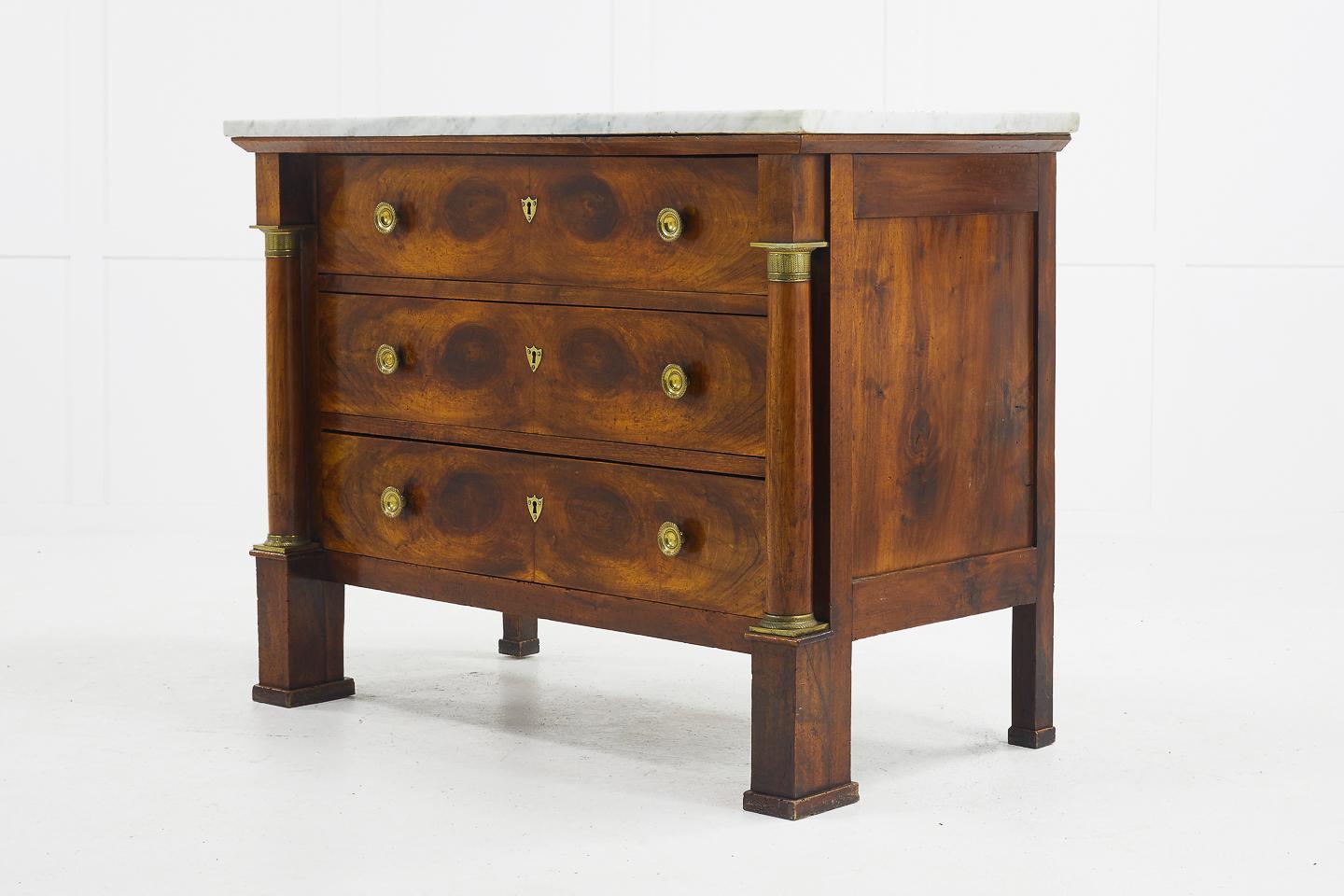 19th century French walnut commode with ormolu mounts. Having a good use of symmetrical, matching veneer patterns on the drawers making this a wonderful example of this style of commode.