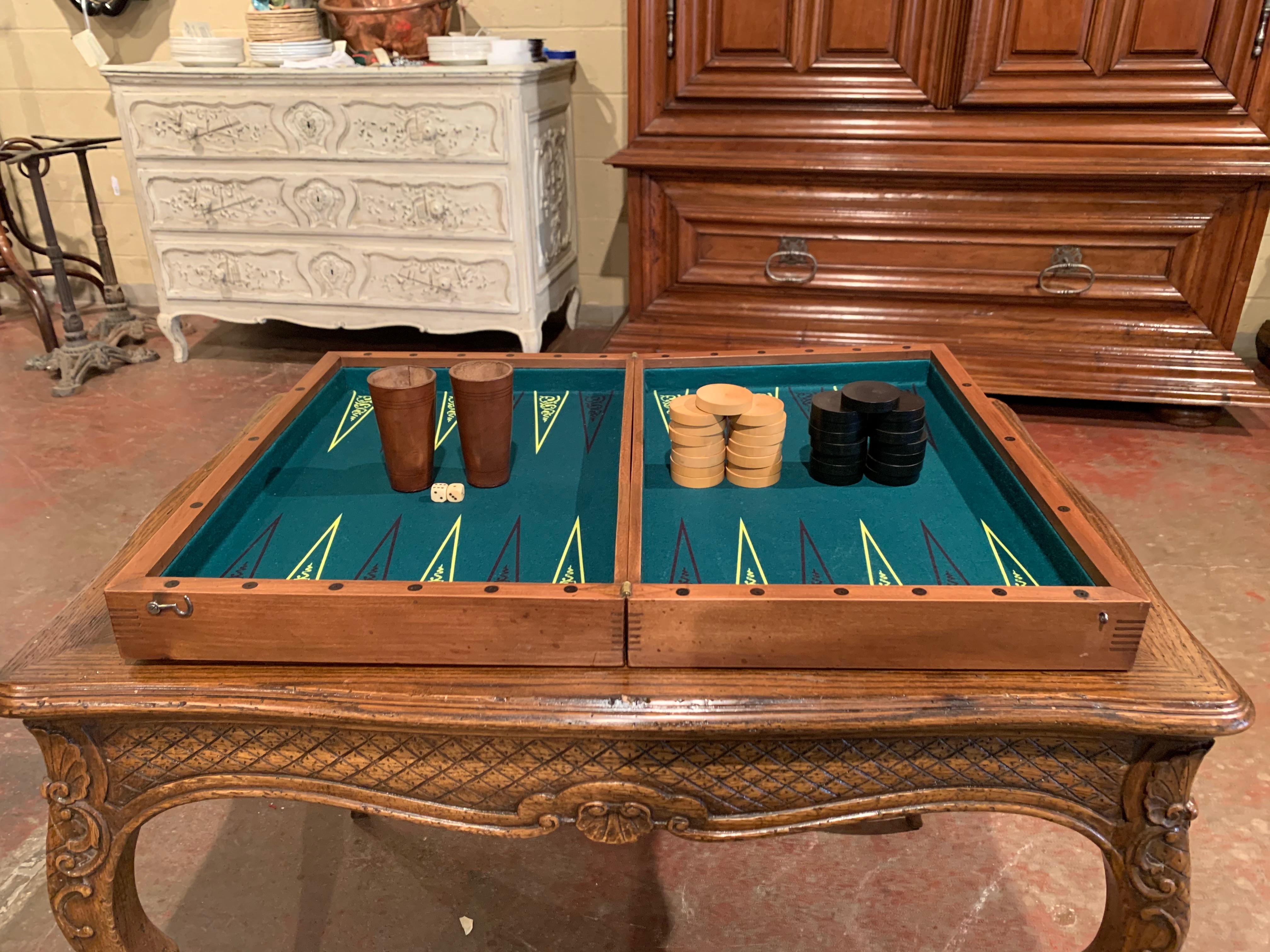 Decorate a study or a game room with this antique checkers or backgammon game; created in France circa 1890, the board game is made of walnut with inlay decor, with green felt in the inside. The game has 30 round pieces including the original two