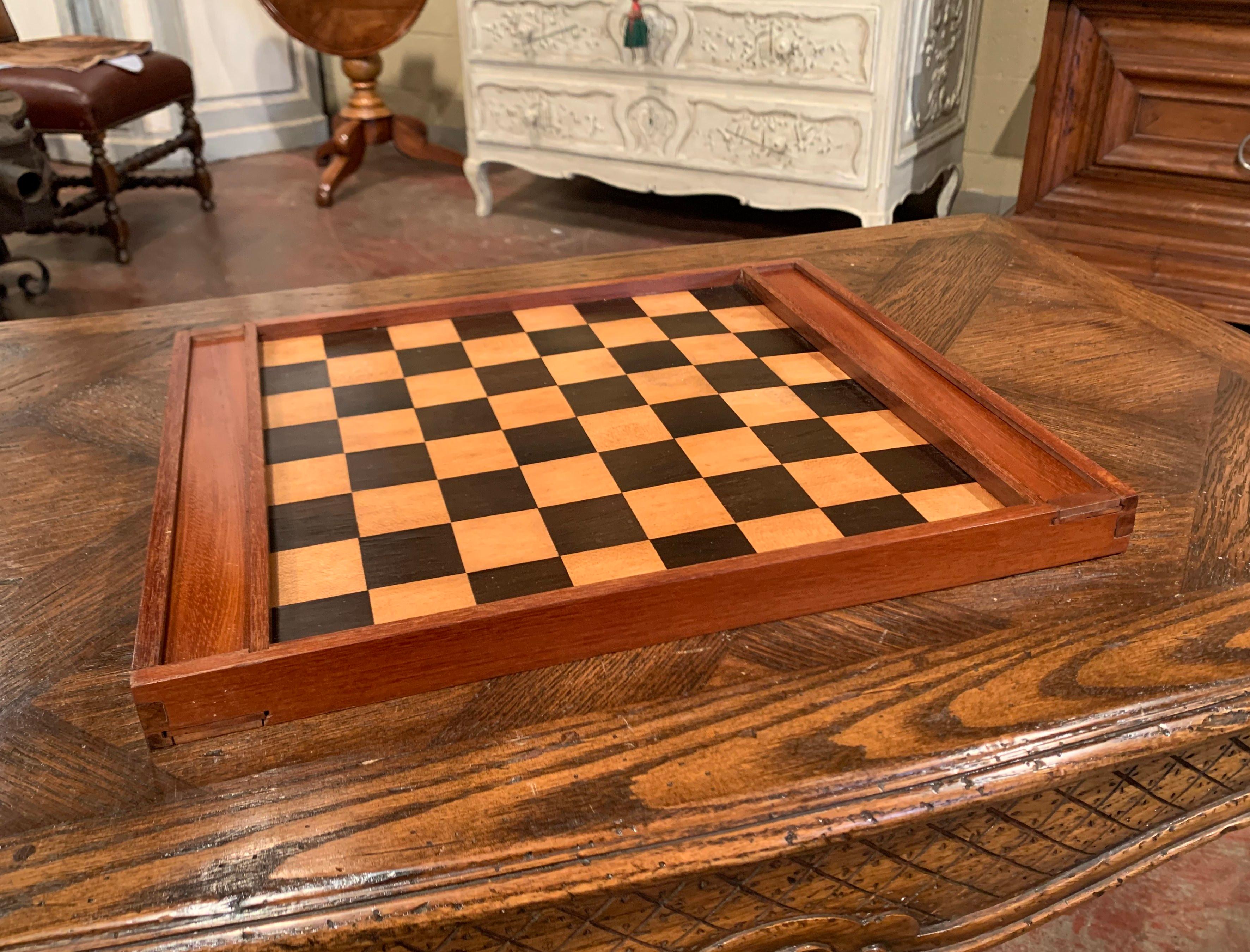 Decorate a card table with this antique checkers game, created in France circa 1890 and made of walnut, the board game is decorated with a two-tone inlay decor on both sides, one top features two chip compartments at each end with sliding door. Both