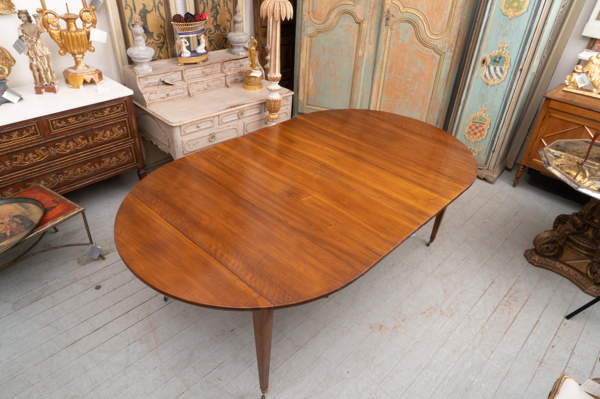 French walnut extension table with four finished leaves. The picture shows the table with two of the 20 inch leaves in place.