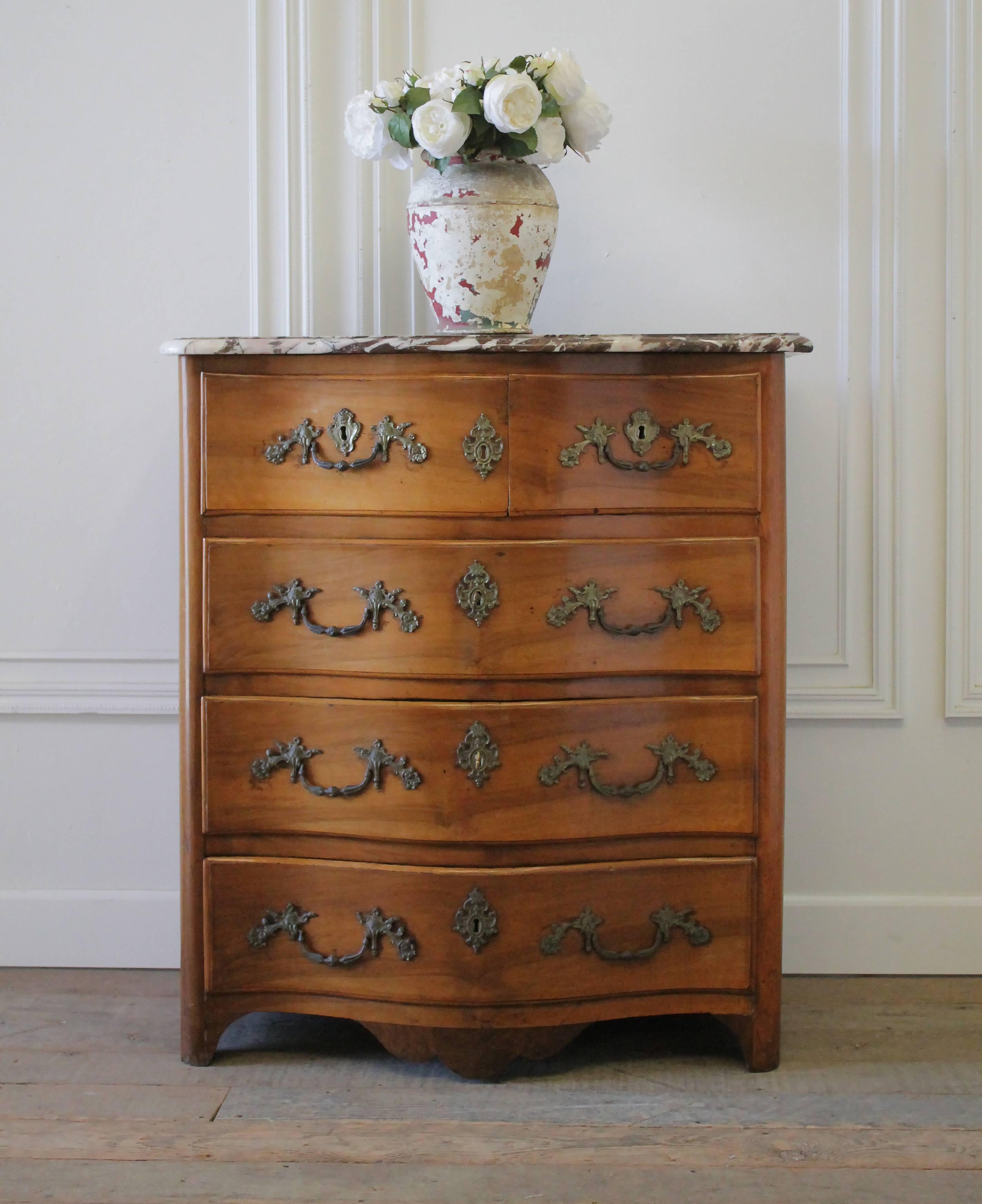19th century French walnut chest of drawers with marble top has five working drawers. Beautiful bronze hardware and decorative escutcheons with aged patina. There are two working keys for this chest, the one key locks the top drawers and second