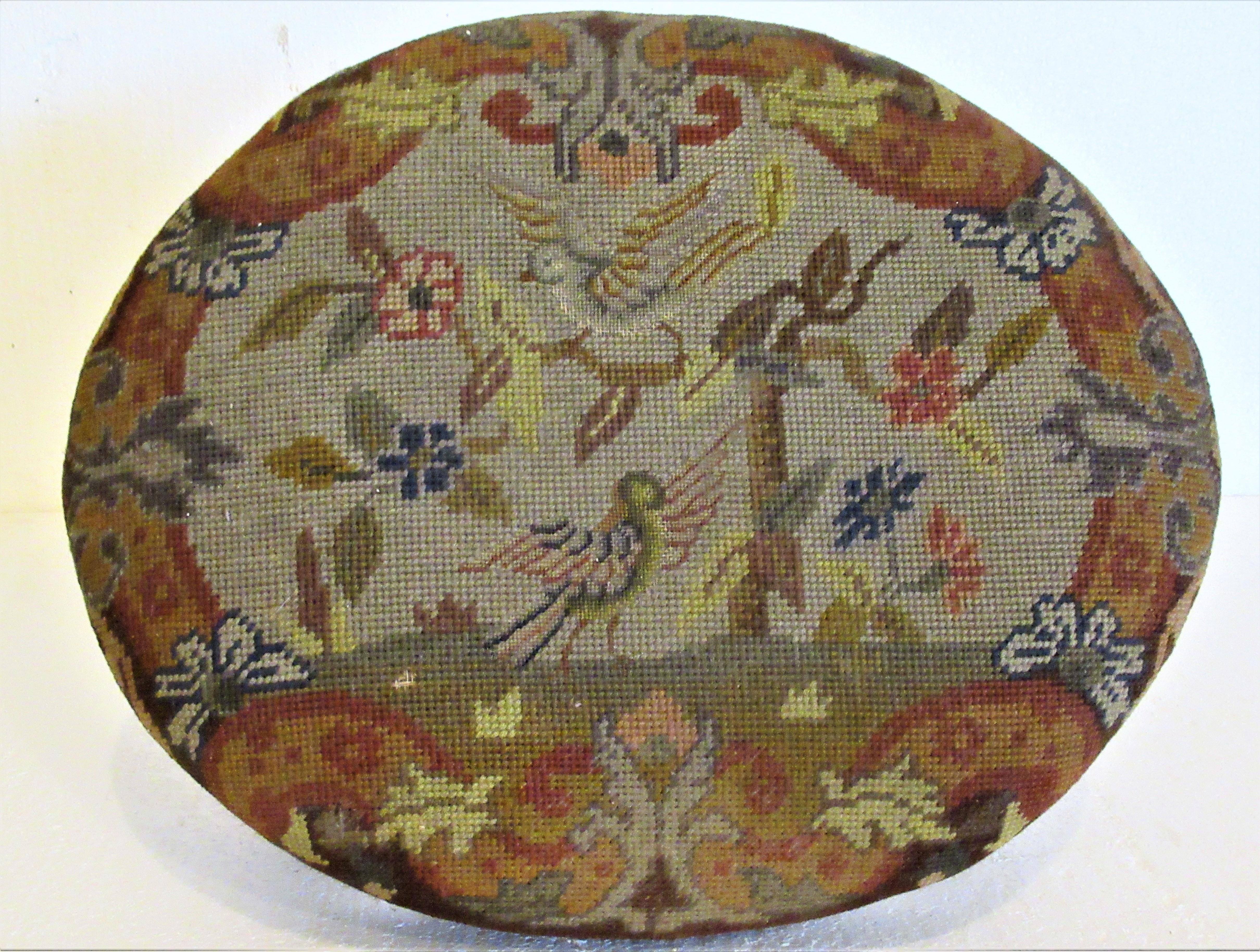 Louis XVI style carved walnut footstool with brass nailhead trim and a beautiful needlepoint tapestry seat. All original antique condition. France, circa 1880-1900. Look at all pictures and read condition report in comment section.
