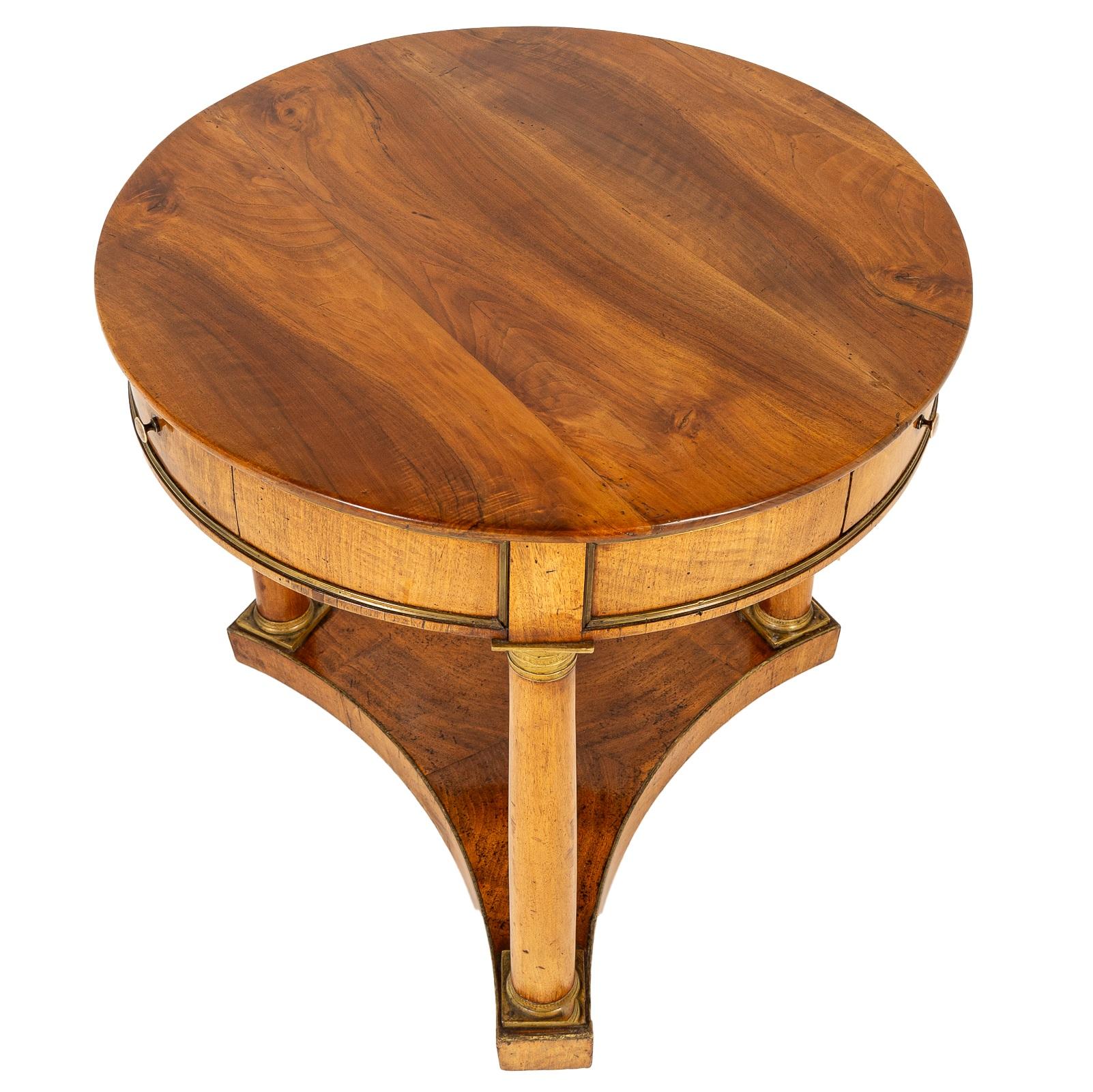 A fine example of classic French furniture, this 19th-century walnut guéridon blends elegance with functionality. 

The three drawers are a distinctive feature of this piece, offering practical storage in an otherwise compact design. 

Designed to