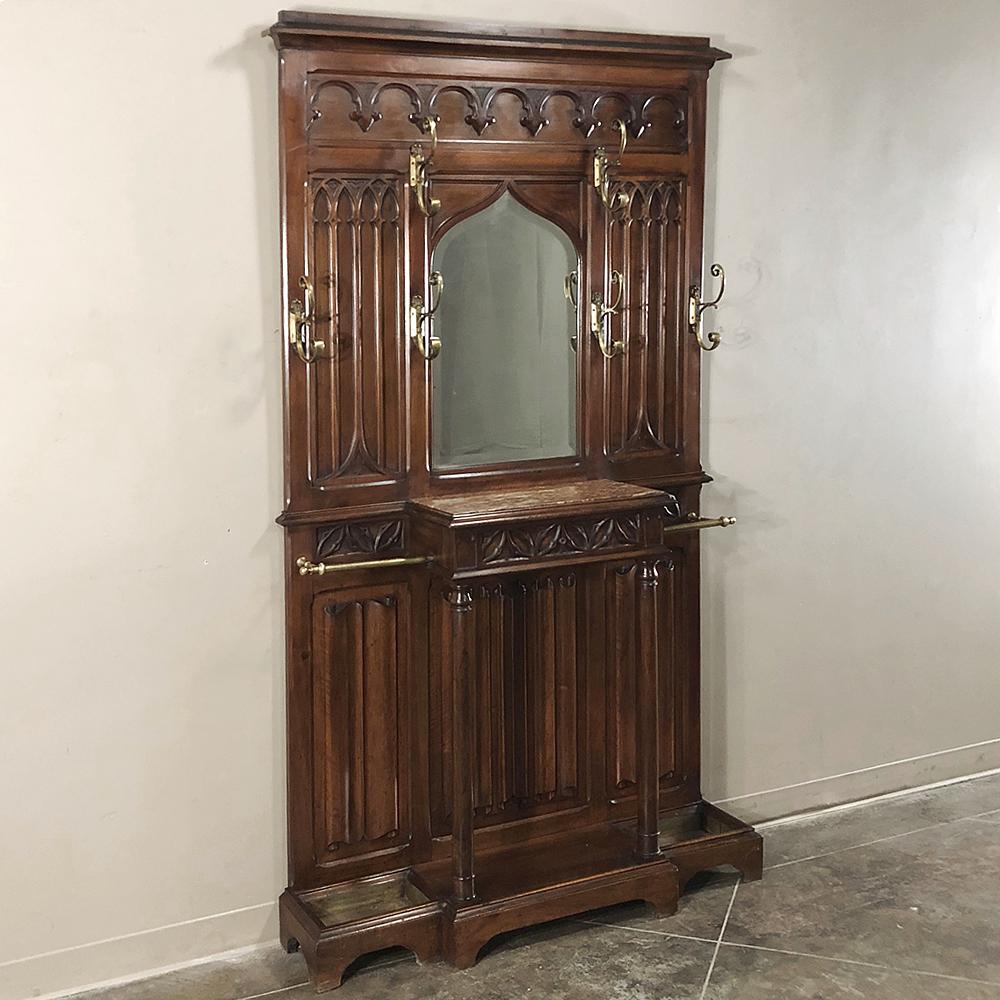 19th century French walnut gothic hall tree was handcrafted from what the experts agree was the finest wood to come from Western Europe. The style is also considered the oldest formal style to emanate from France, and was used for everything from