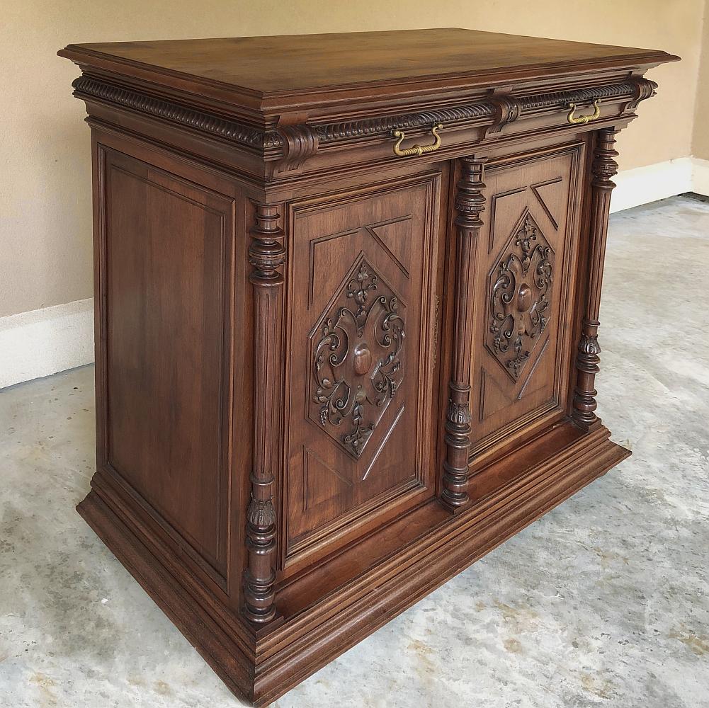 19th century French walnut Henri II Buffet is a special expression of classical architecture that was revived during the reign of Napoleon III, and features stylized Renaissance-inspired embellishment such as the elaborate heraldic crest form