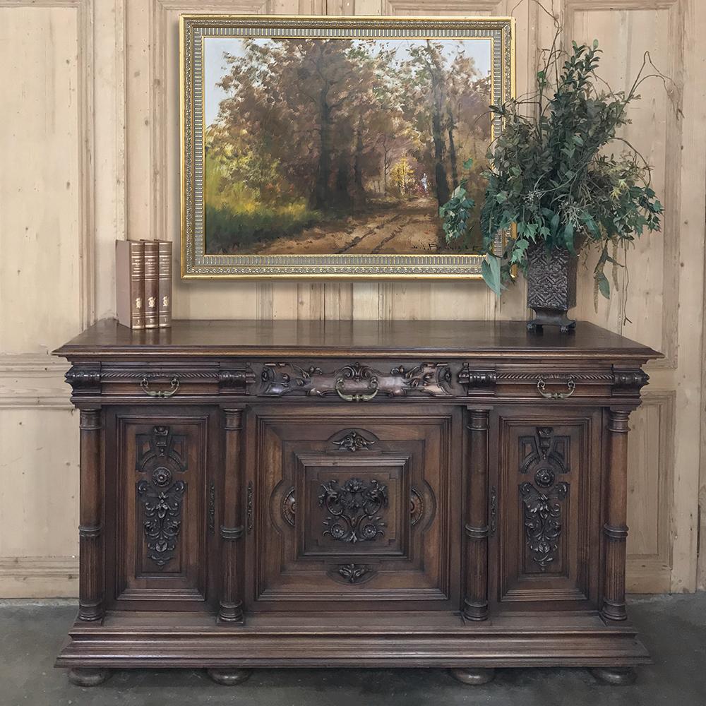 19th century French walnut Henri II Buffet features carved embellishment influenced by the Renaissance and Baroque styles. Stylized, more abstract forms are typical of the waning years of the period's influence. In this piece, a particularly high