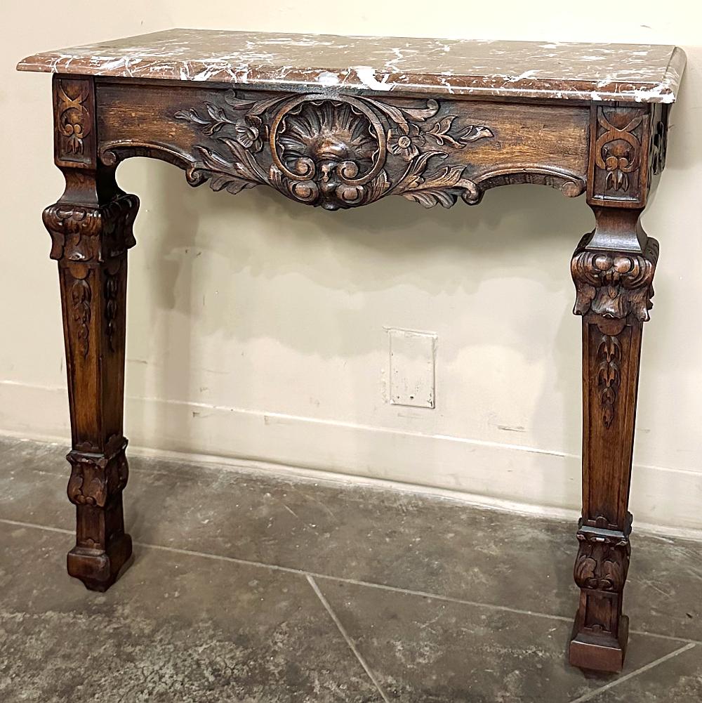 19th Century French Walnut Louis XIV Marble Top Console is an exquisite example of the style named after the Sun King that combined Baroque ornamentation with classical architecture to create a truly timeless look!  Hand-carved from French walnut it