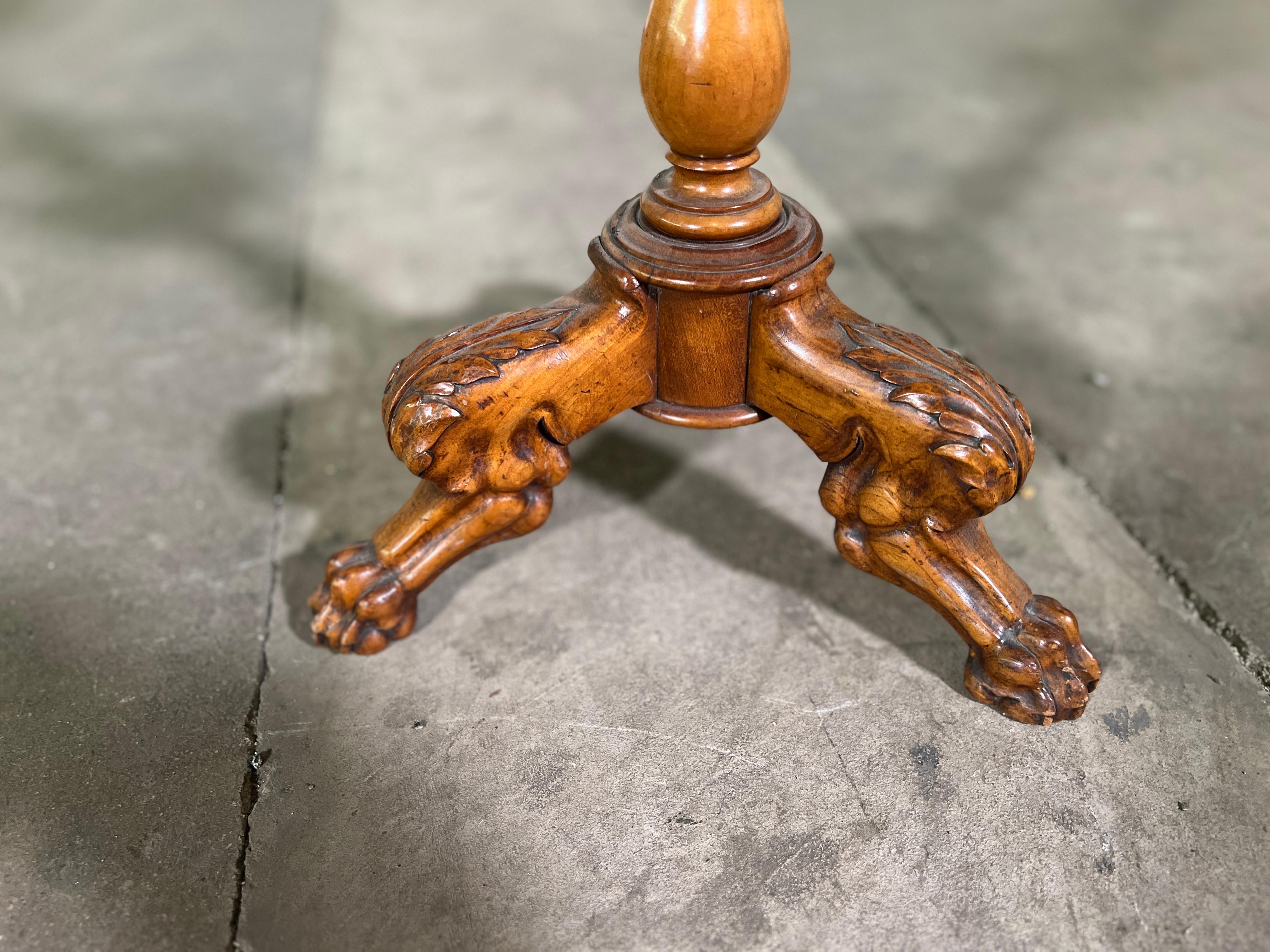 19th Century French Walnut Petite Gueridon with beautifully carved lion feet.