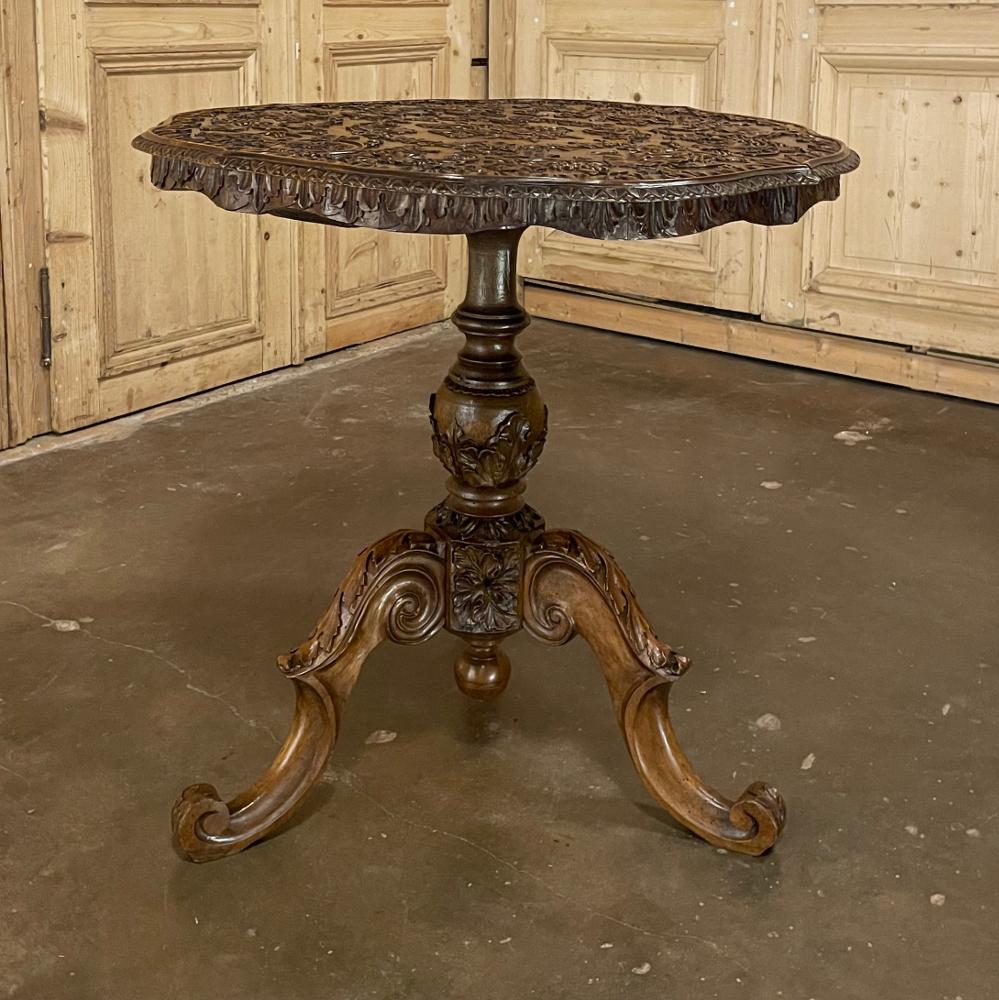 19th century French walnut Renaissance carved center table is the perfect choice for the wine connoisseur! Artistically carved across the entire top, the apron, the central pediment, and even the trio of scrolled legs, it must be examined closely to