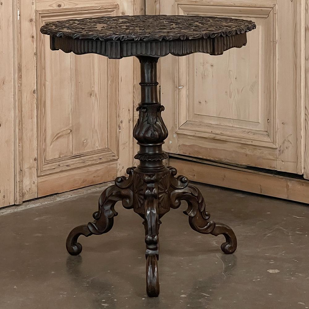 19th Century French Walnut Renaissance Carved Center table is an exceptional work of the sculptor's art that also happens to be a very functional table! Artistically carved across the entire top, the apron, the central pediment, and even the trio of