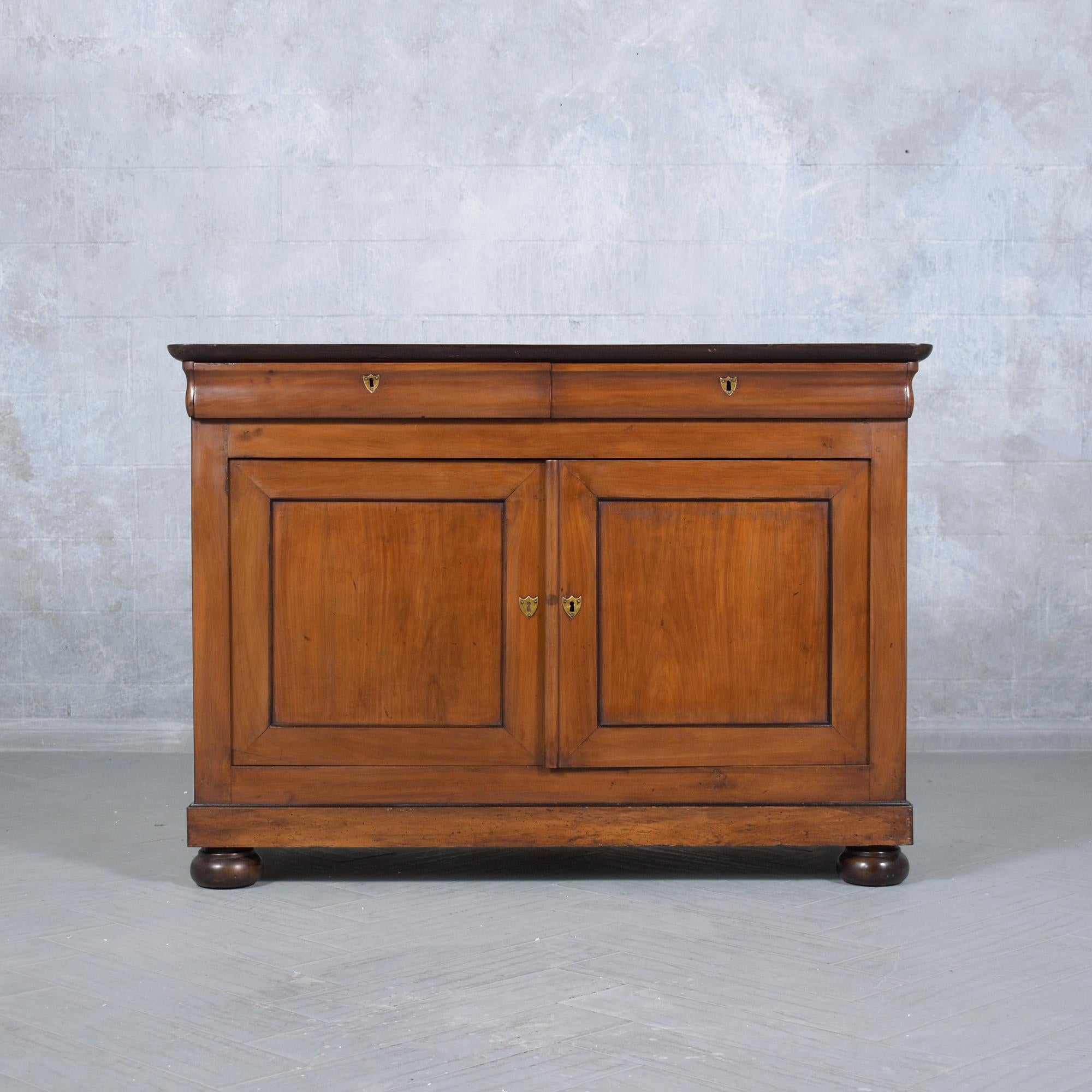 Journey back to an era of unparalleled elegance with our 19th-century French Server, a gem of antique craftsmanship and design. Expertly restored by our dedicated in-house craftsmen, this walnut wood sideboard is a living testament to the