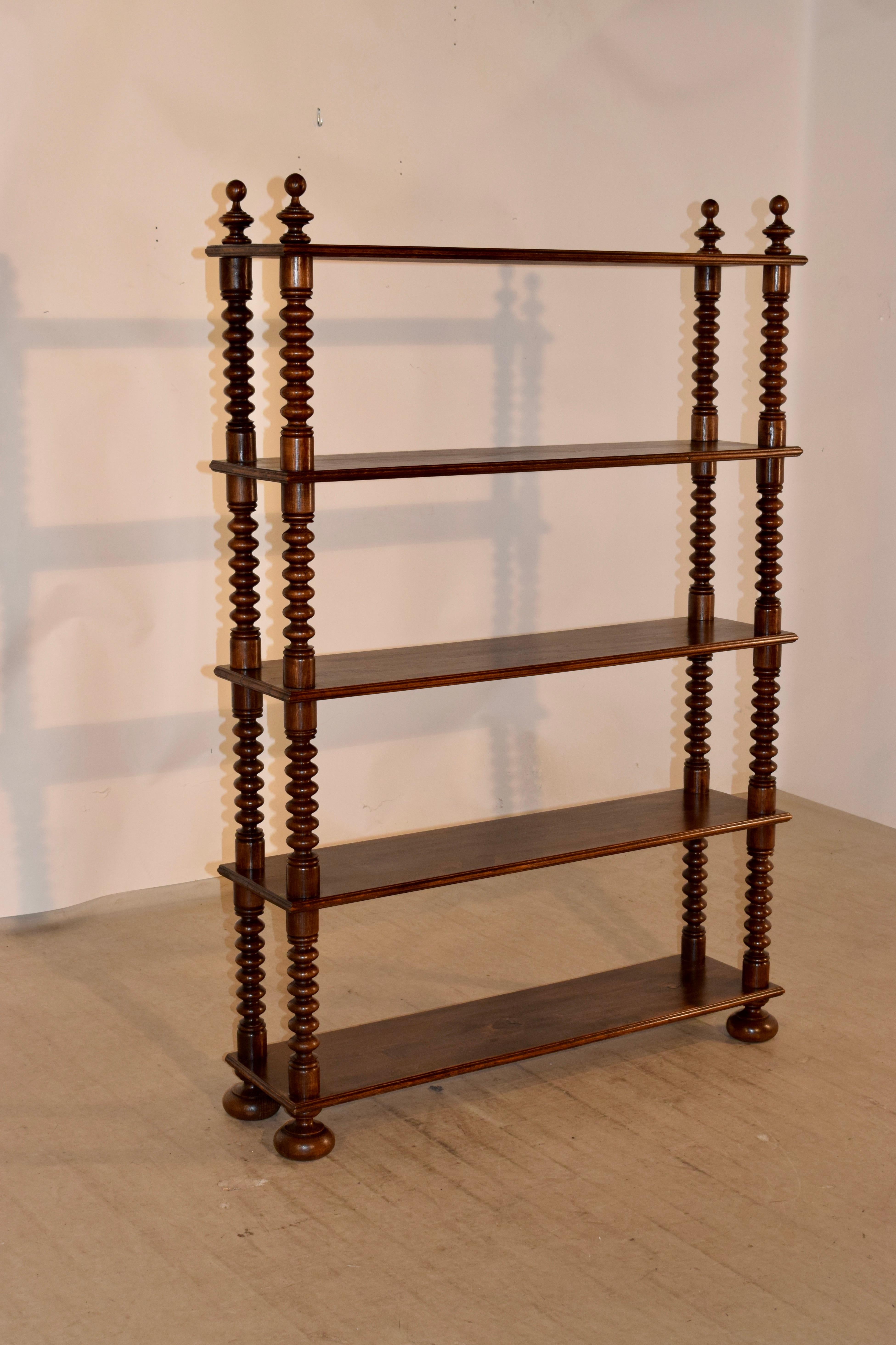 19th century French standing shelf made from walnut. It has lovely hand turned finials and shelf supports in a bobbin pattern, and is resting on lovely hand turned bun feet.