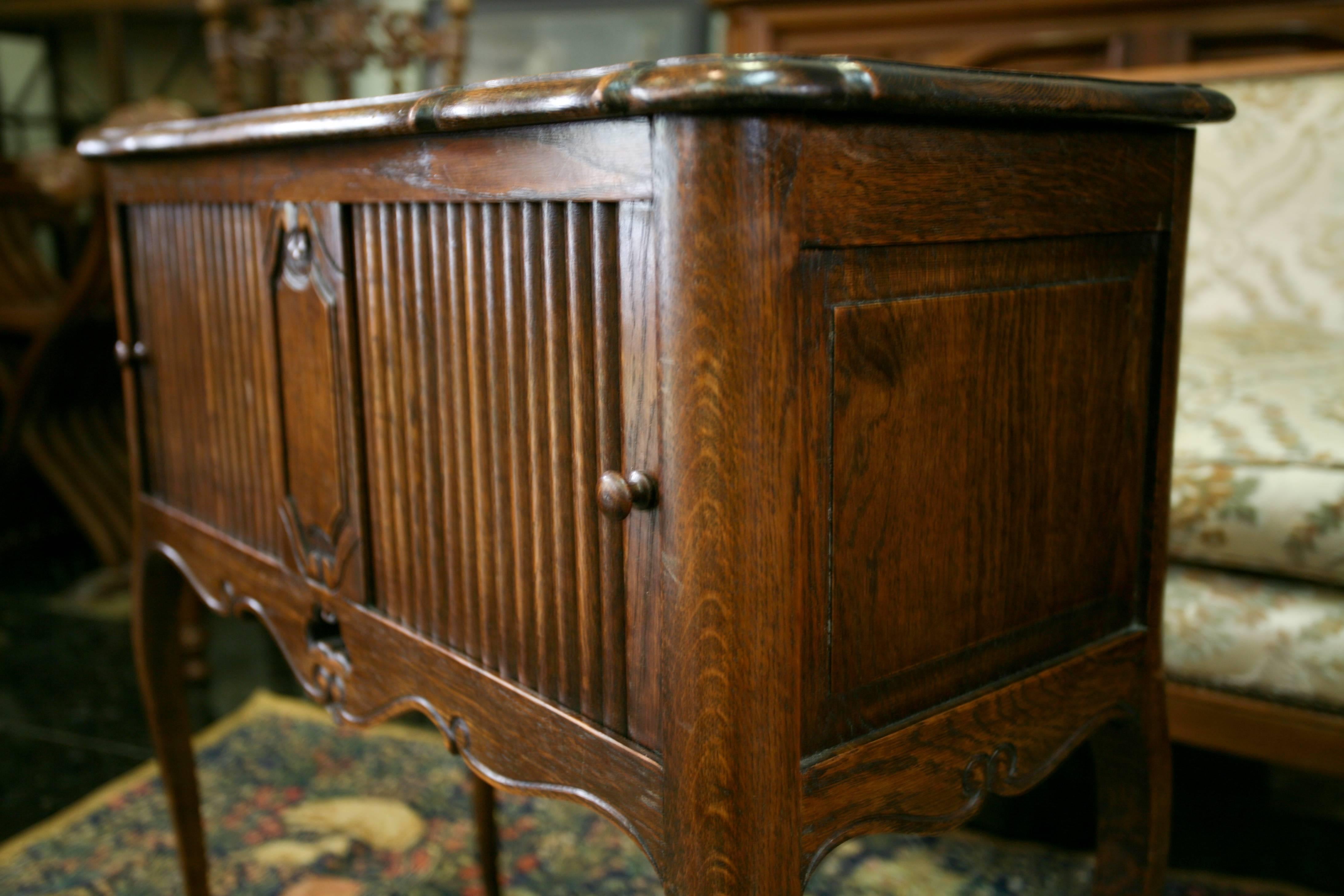 19th century French side cabinet or nightstand in Louis XVI Style. Made of hand-carved walnut it has two sliding hiding doors and is in perfect antique condition with only minor sins of wear and use for their age.
circa 1880.