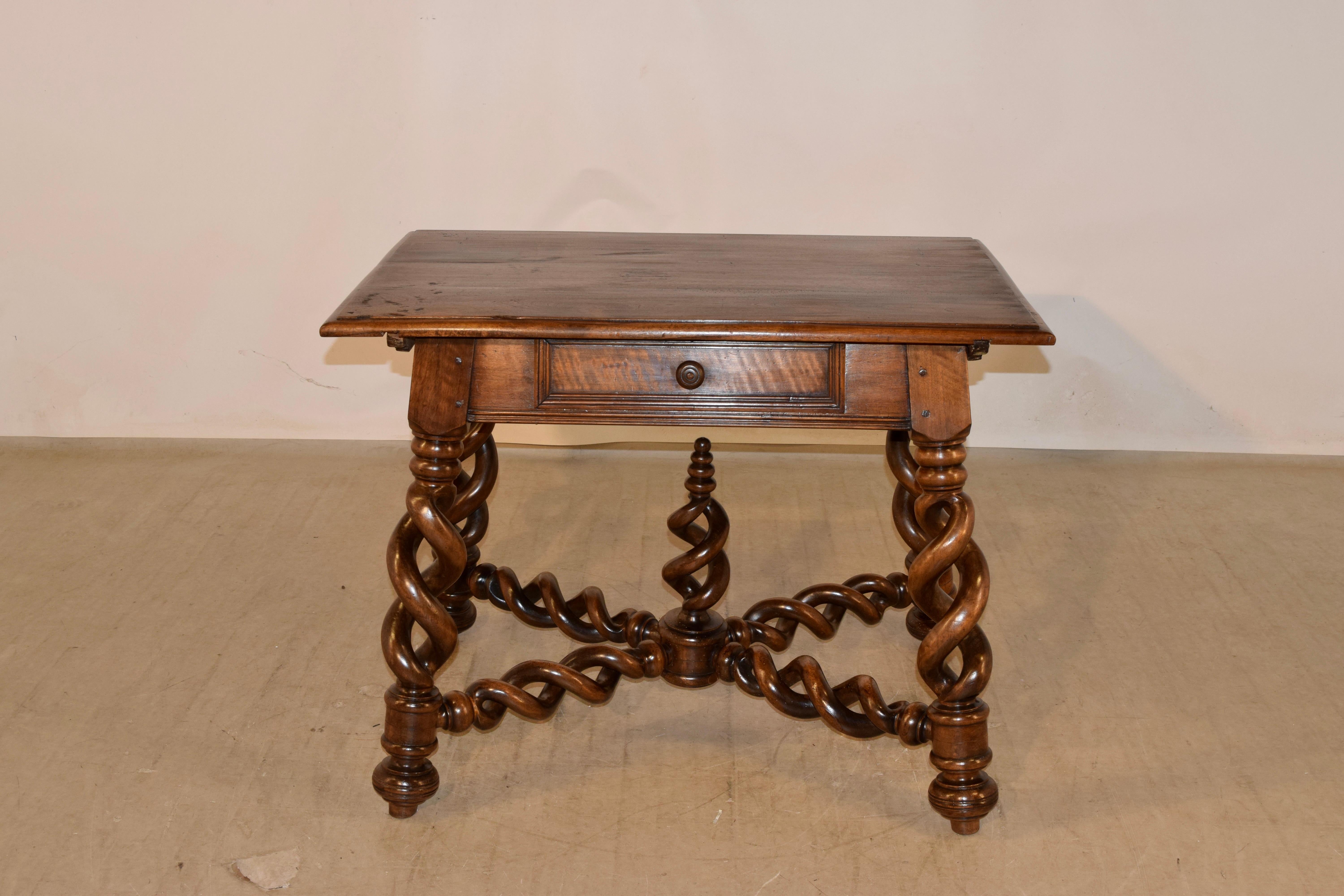 Fabulous 19th century walnut side table from France with a beveled edge around the top, following down to a simple apron with a lower molded edge and a single drawer in the front. the table is supported on hand turned exquisite open barley twist