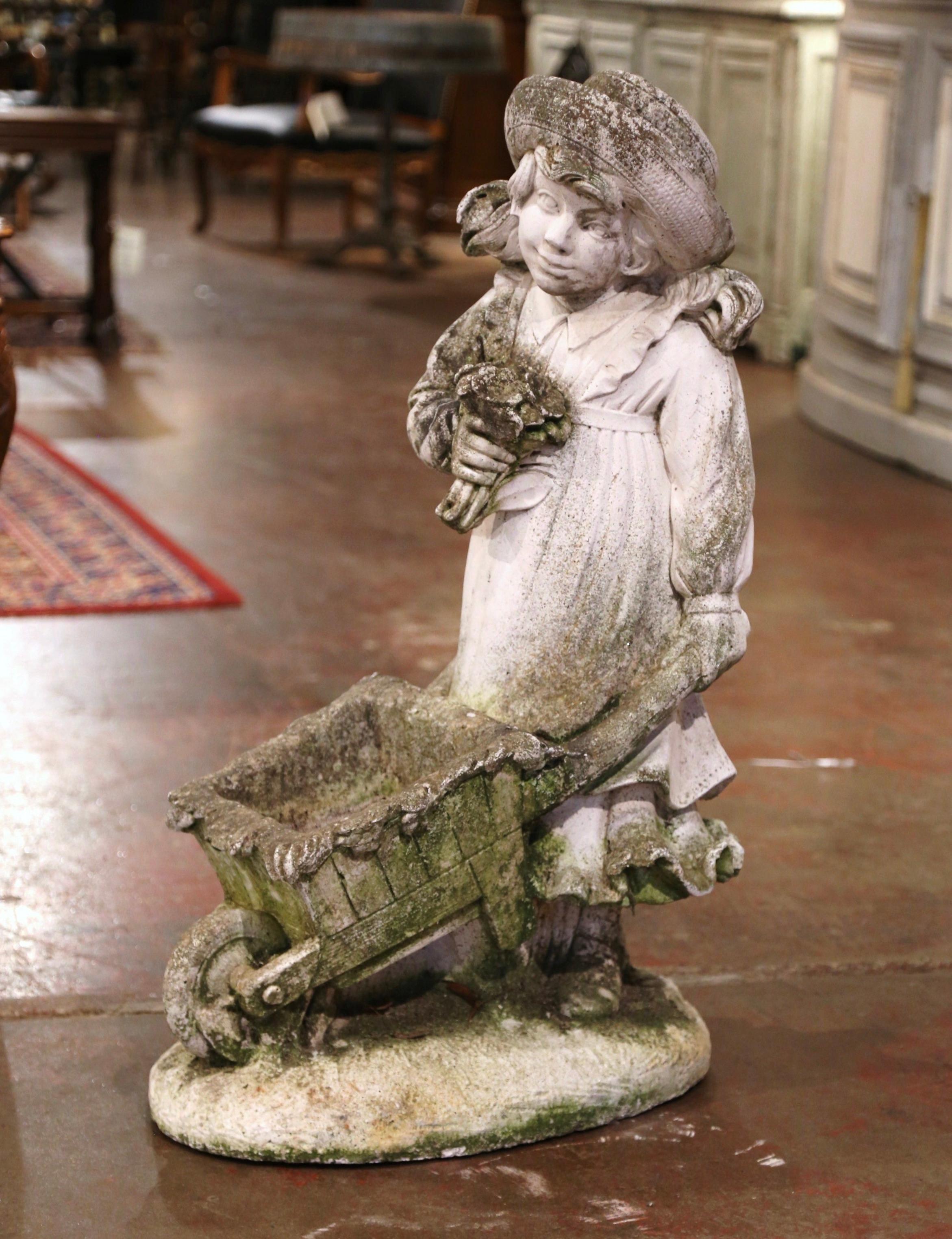 Decorate a garden or patio with this elegant antique outdoor sculpture composition. Carved in France circa 1880, the large sculpture stands on an oval base, and depicts a young sweet girl in lace dress and wearing a hat; she is holding a bouquet of
