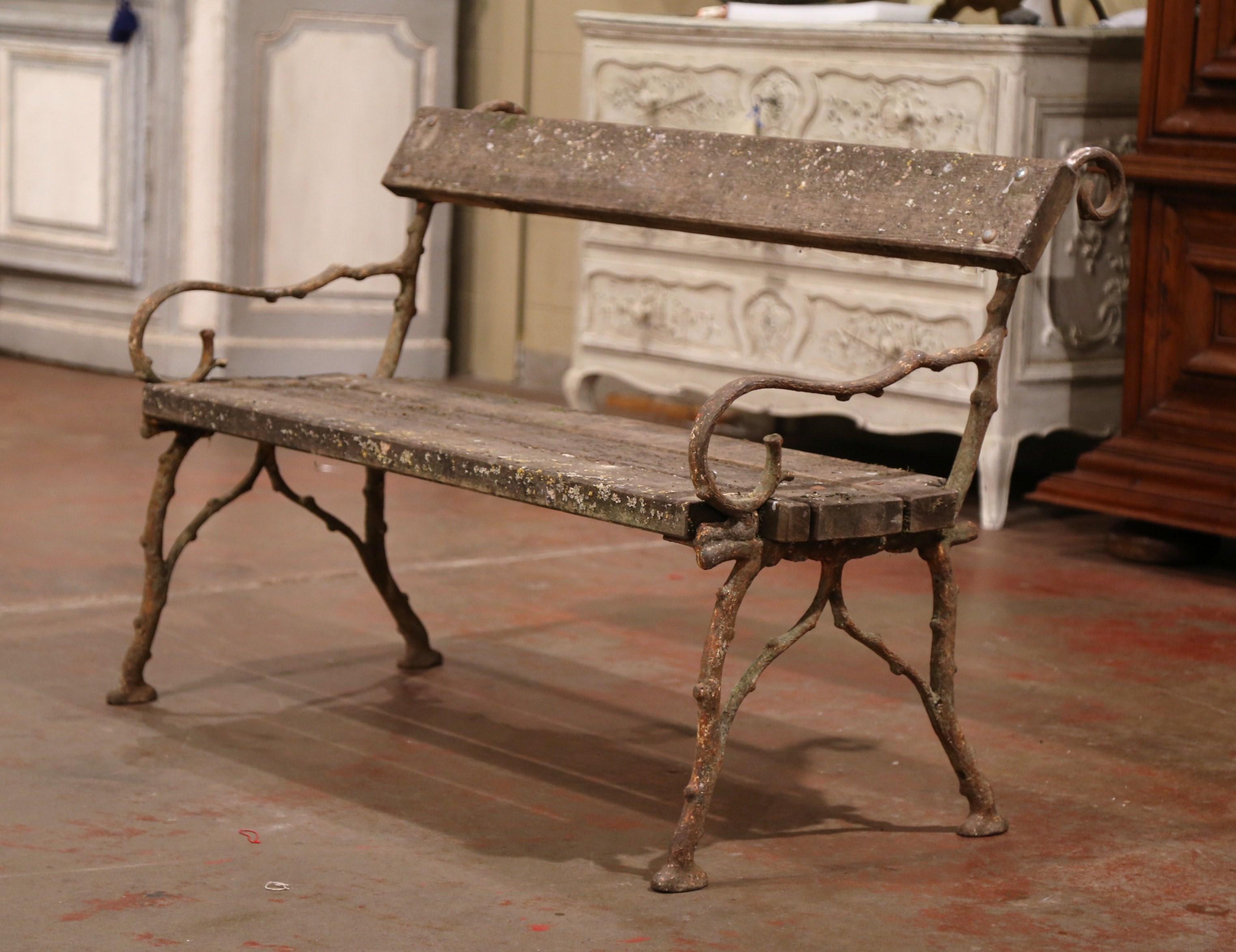 This wonderful antique bench was found in a Normandy manor, crafted circa 1860 and made of iron shaped as tree branches, and oak planks, the bench adorns the original weathered finish which was left as authentic as it was. The seating is in