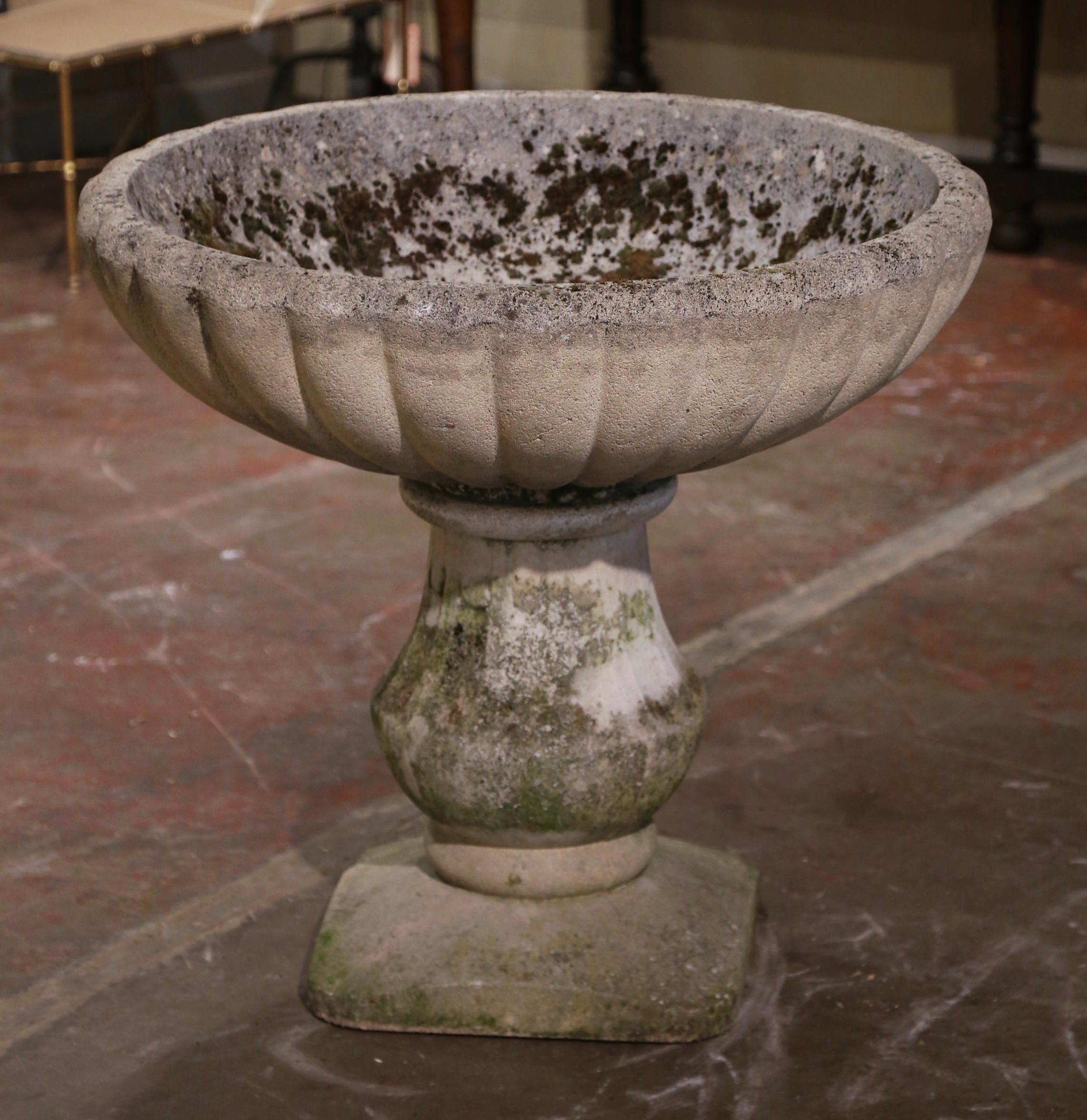 Place this elegant antique planter on your patio or garden for a timeless flower display. Crafted in France circa 1880 and built in two pieces, the large sturdy stone jardinière sits on a solid square base over a turned pedestal. The top features a