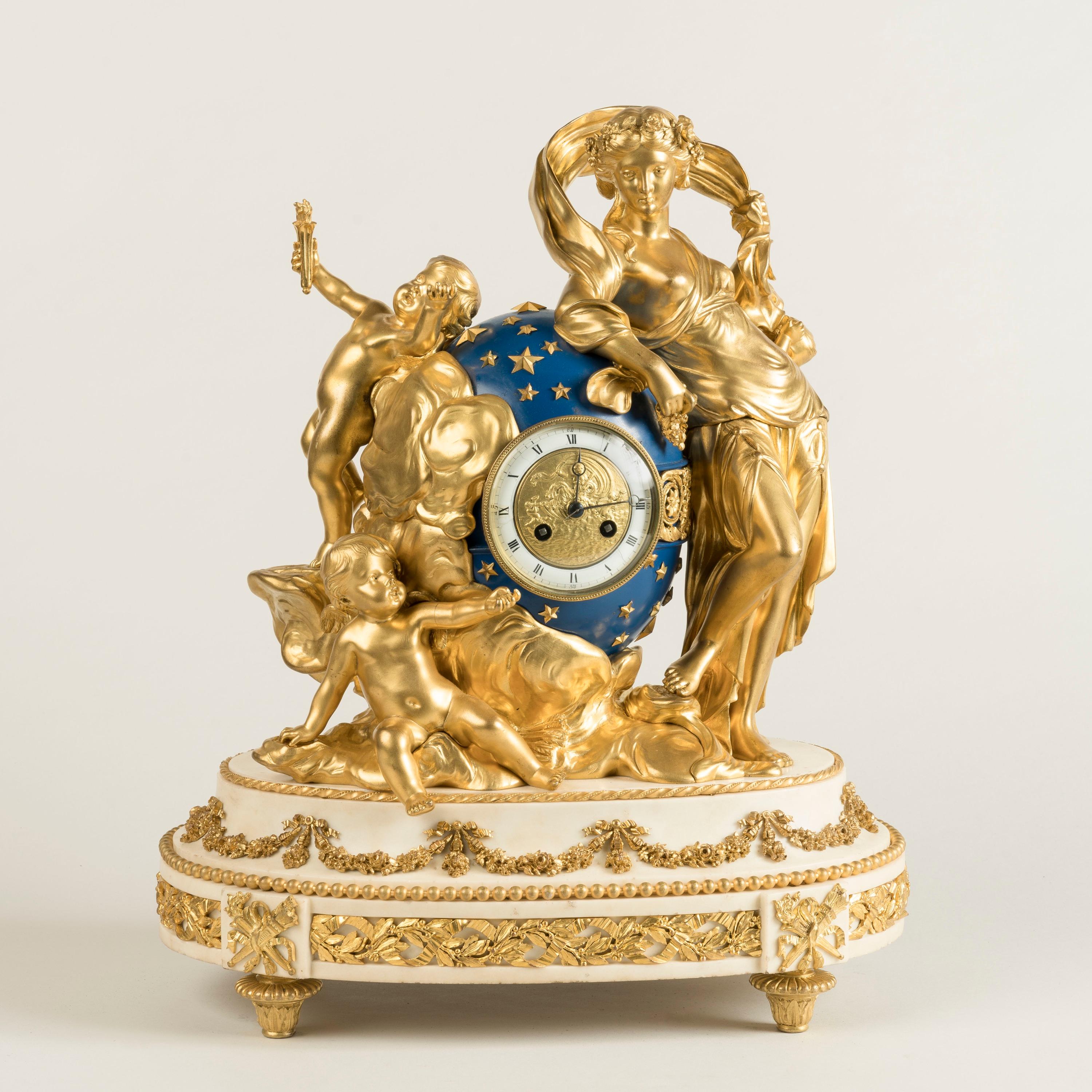 An Impressive Marble and Gilt Bronze Mantel Clock
In the Louis XVI Manner

Constructed from a marble platform with a bronze group above; all confidently dressed with exquisite hand-chased and me rcury gilded ormolu mounts, rising from three toupie
