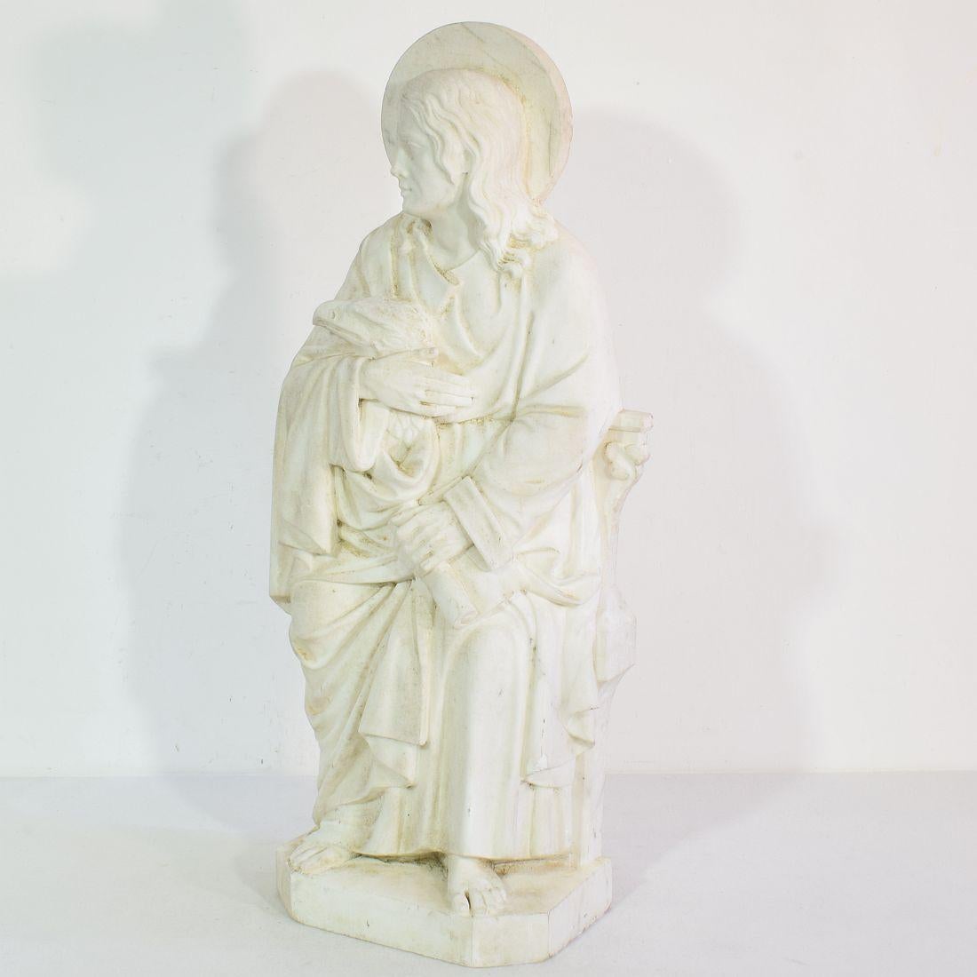 Beautiful weathered white marble statue representing Saint John the Evangelist.

Christian tradition says that John the Evangelist was John the Apostle. The Apostle John was one of the 