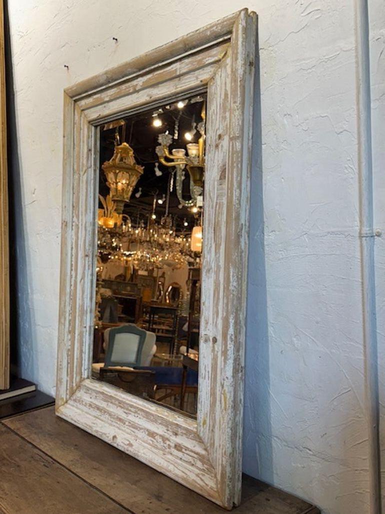 The 19th Century French White-Washed Pine Mirror exudes a pretty rustic style. This antique mirror features nice details and craftsmanship, making it a unique and valuable piece for those looking to add a touch of charm to their living space. Its