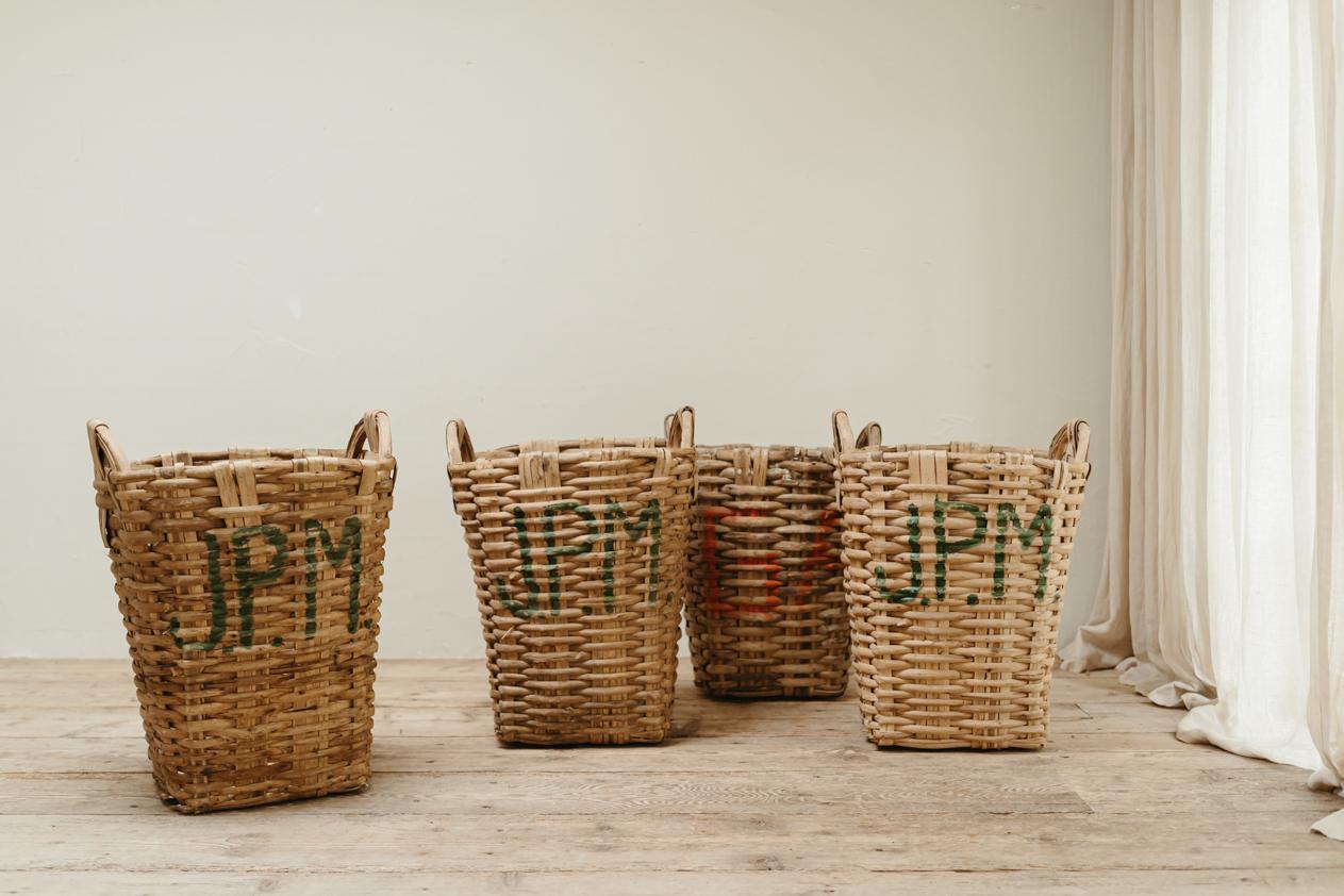 lovely set of 4 wicker. baskets, used in a French factory to store cotton. Can be used as baskets for linnen, cushions or next to the log fire to store wood.