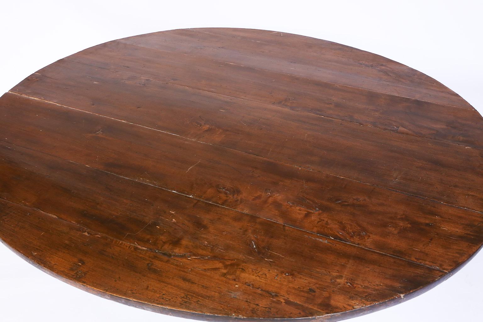 French wine tasting table, also known as a vendage or vigeron table, which was once used in the vineyards of France for tasting wine or enjoying a meal. This table would be suitable for use in a breakfast area or wine cellar. Featuring a tilt-top,