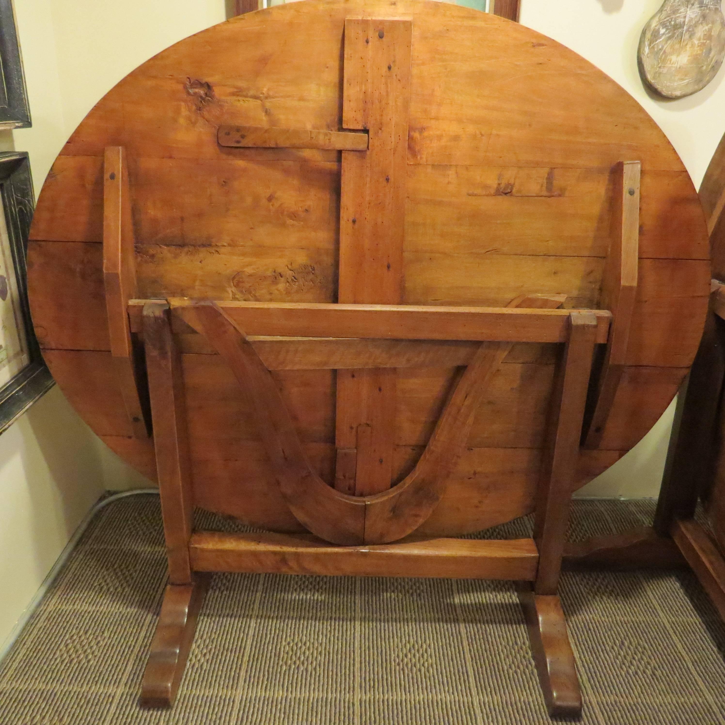 This 19th century handmade, wooden table is typical of the flip top style used in French wine callers. It can rest near the wall, or flip up for serving.