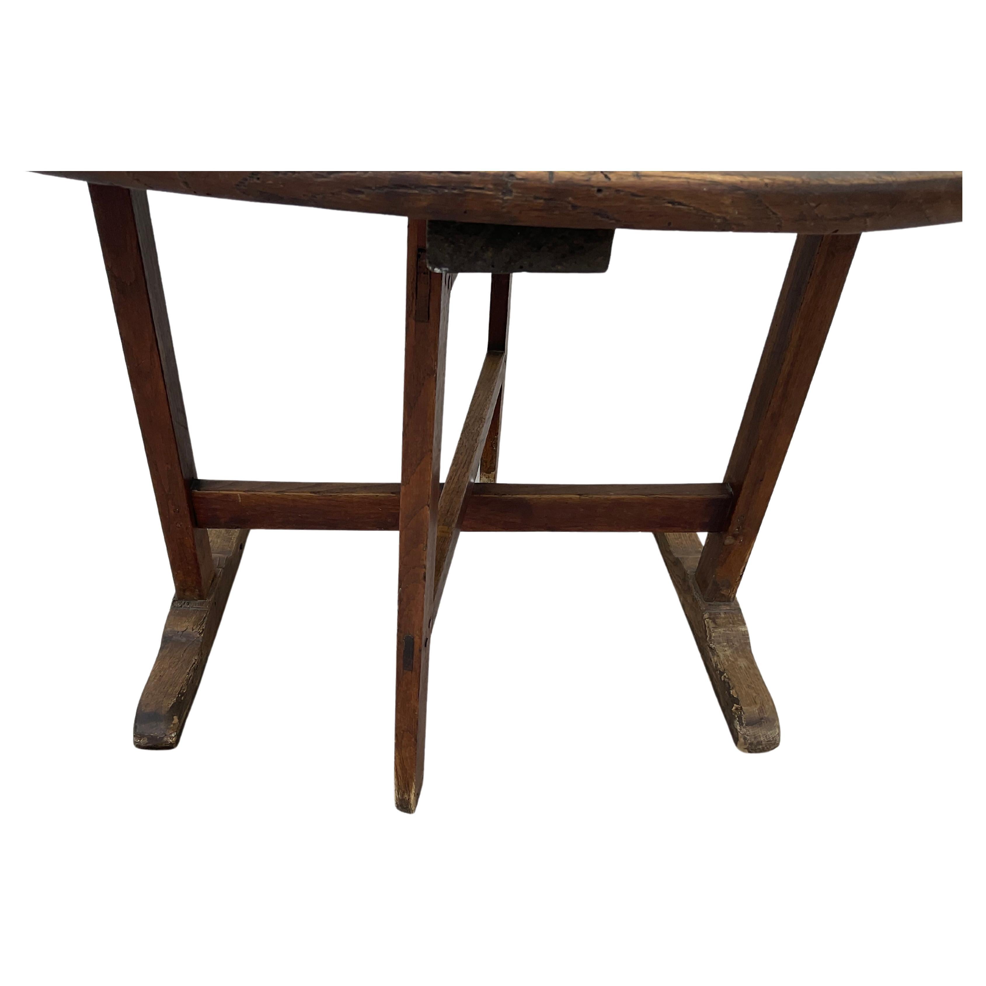 Unique 19th century French tilt-top wooden wine tasting table (“table de vendange”). These tables were commonly used in vineyards of France during the grape harvest season.  Versatile table can be  opened as a 38” round dining or side table, or