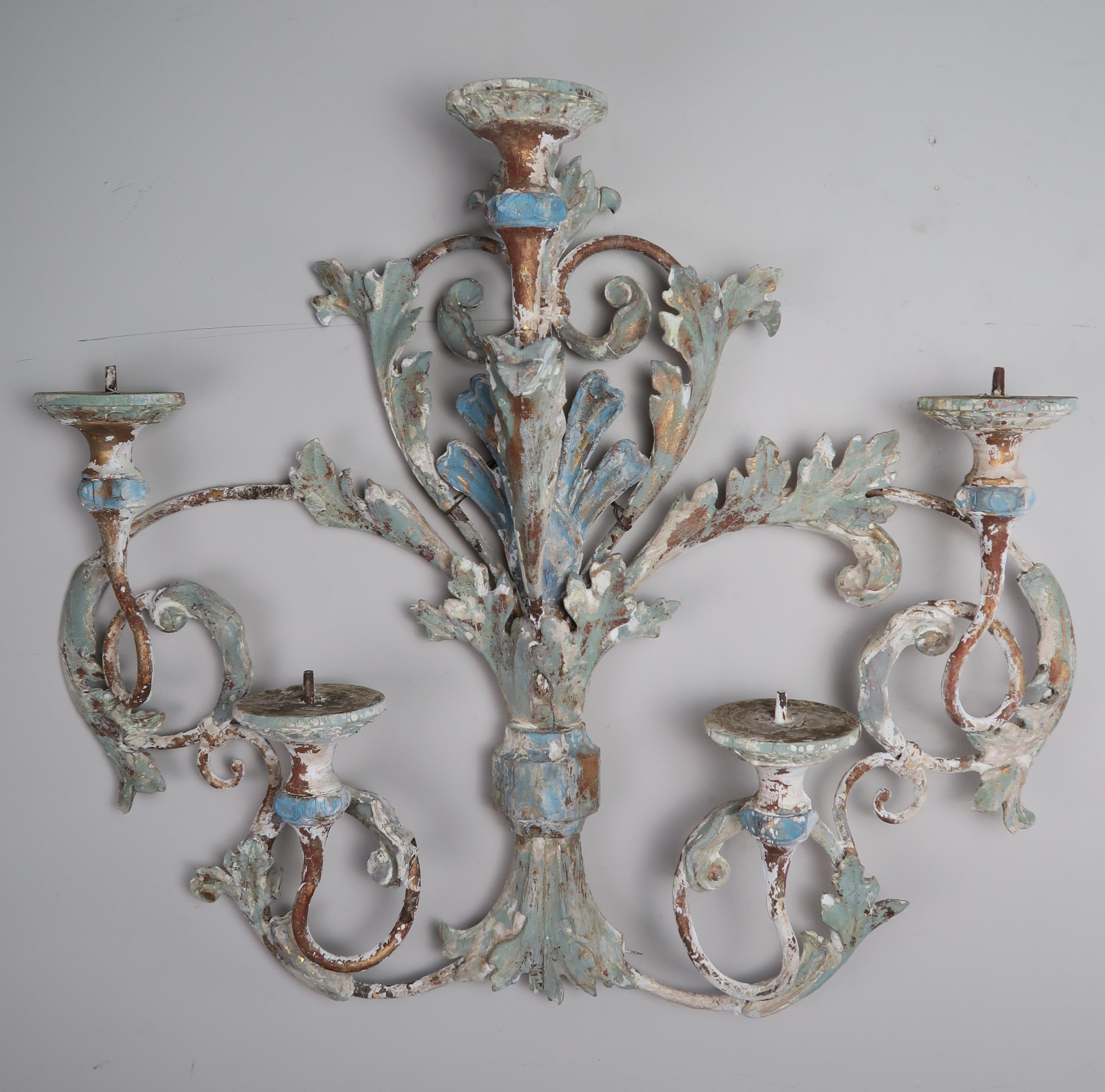 19th century French wood and iron painted carving. The carving depicts swirling acanthus leaves in soft hues of blue, green and cream colors. The paint is beautifully worn with portions of iron showing underneath.