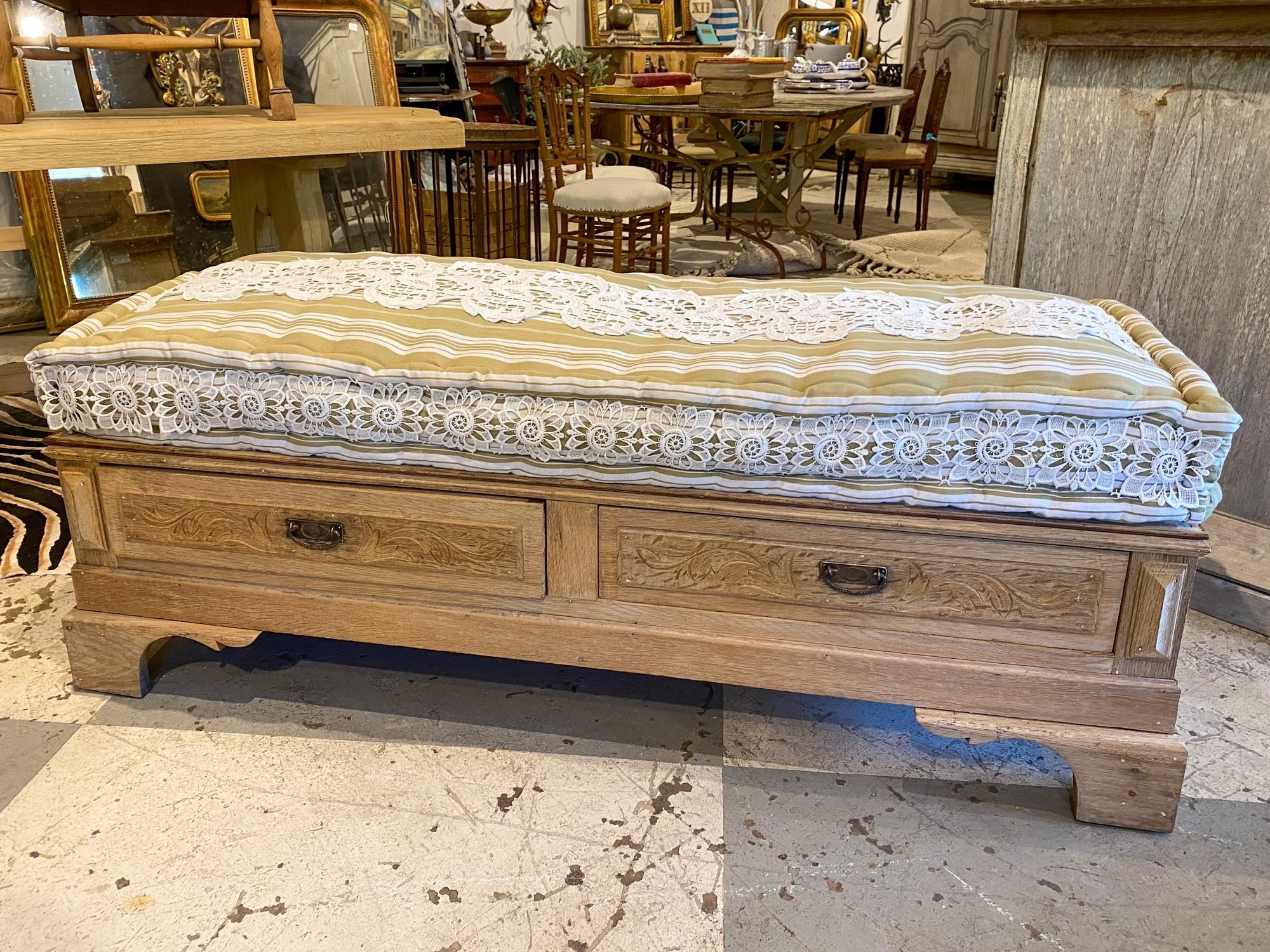 This multifunctional banquette bench was crafted by deconstructing a 19th century French Oak commode. The body of this piece dates to the 1880s, with two drawers and a newly added flat wood top. The original finish has been stripped and a cushion