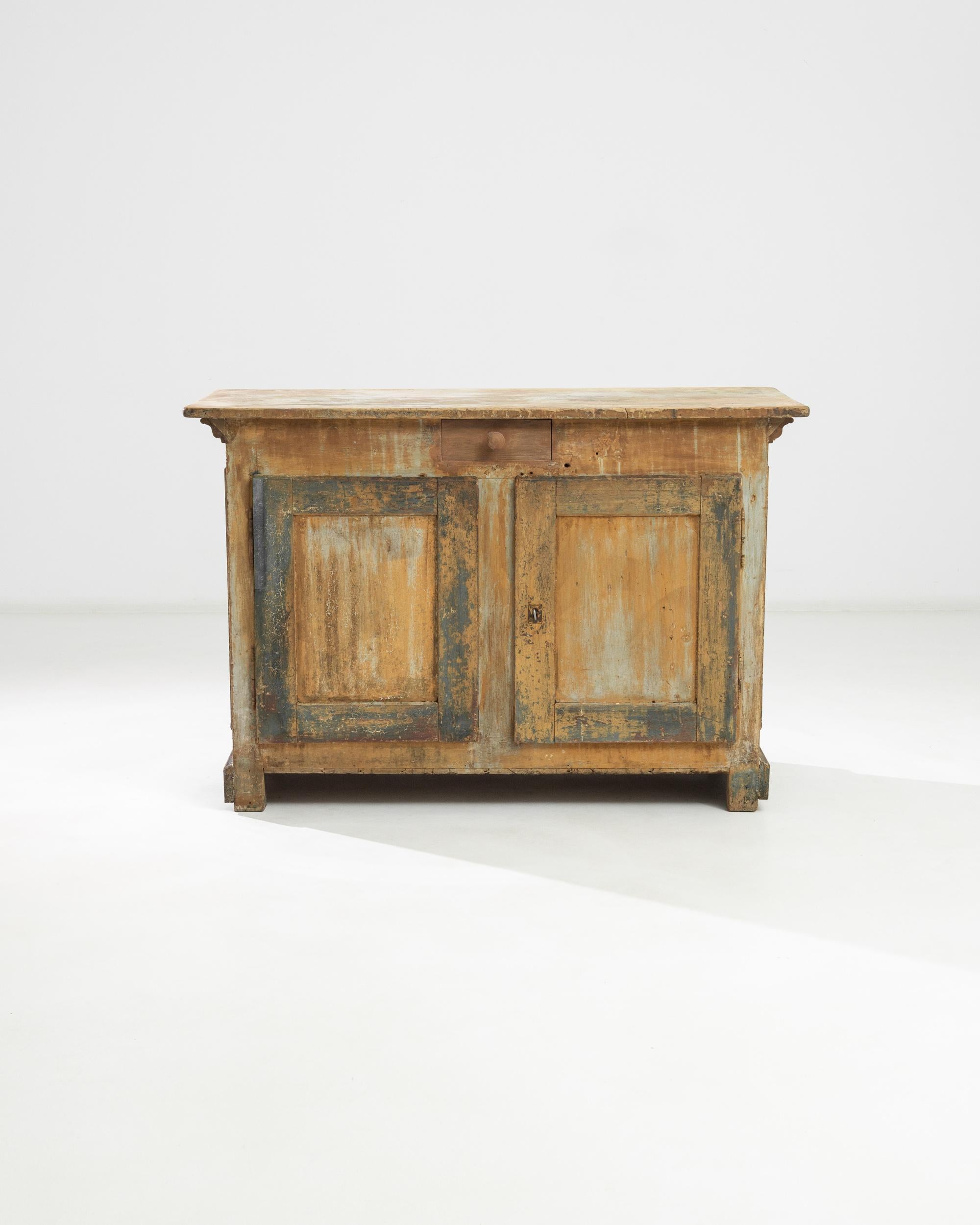 A wood patinated counter from France, produced during the 19th Century. A classic buffet in its original patina standing waist high, from the other side a bar; featuring a locking double cabinet and single, center drawer. The pair of raised, blue