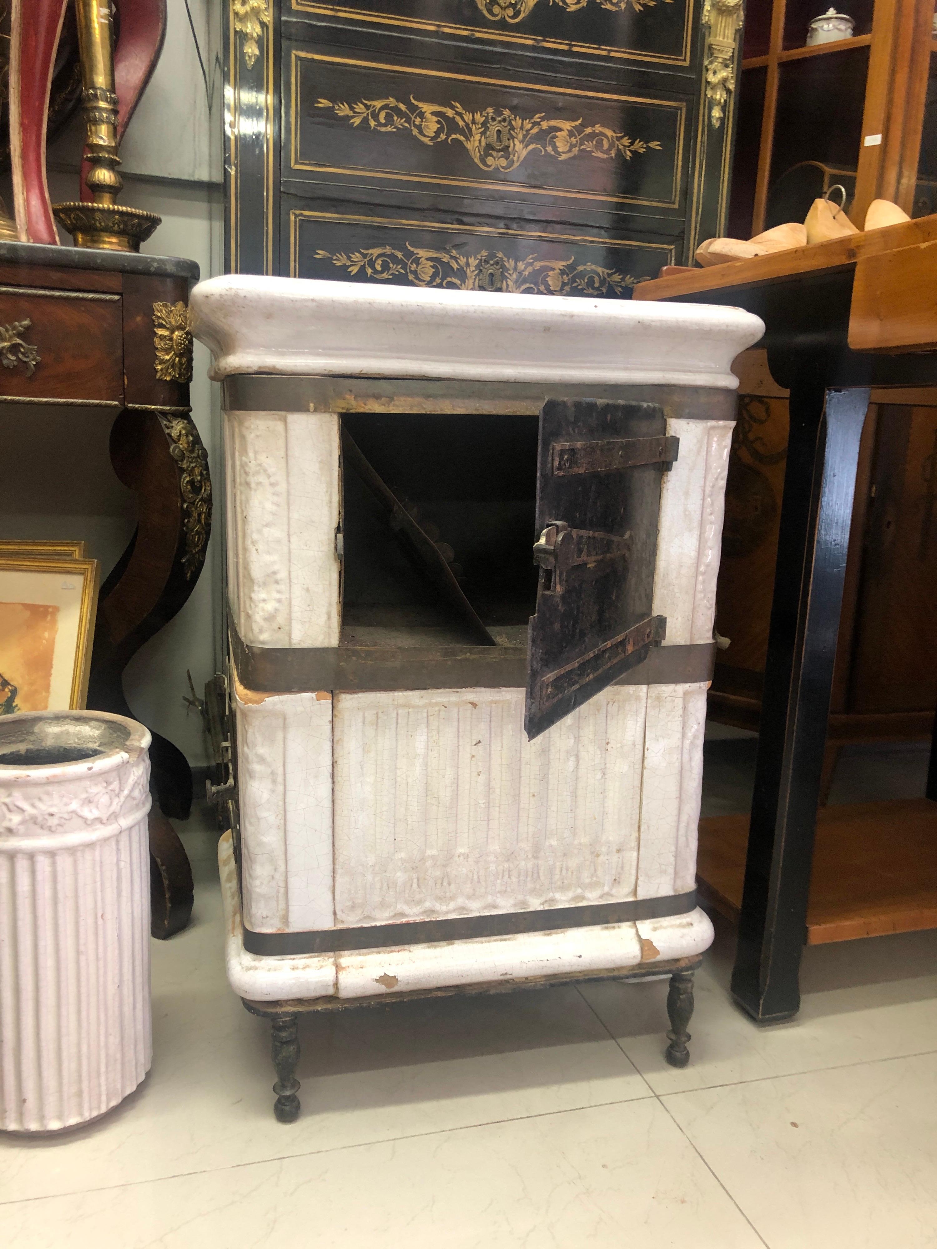Beautiful white ceramic stove made in France, circa 1880.
The wood to be loaded from side door and heat to be used for cooking or just heating from front door.
The piece is nicely decorated with floral elements.
France, circa 1880.