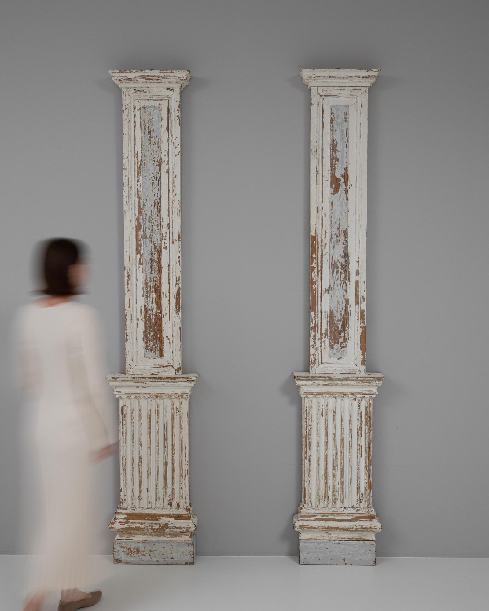 These 19th Century French Wood Columns, offered as a pair, are an exquisite find for anyone with a passion for classical architecture and vintage decor. Each column stands tall with an elegant, fluted design, topped with Corinthian capitals that
