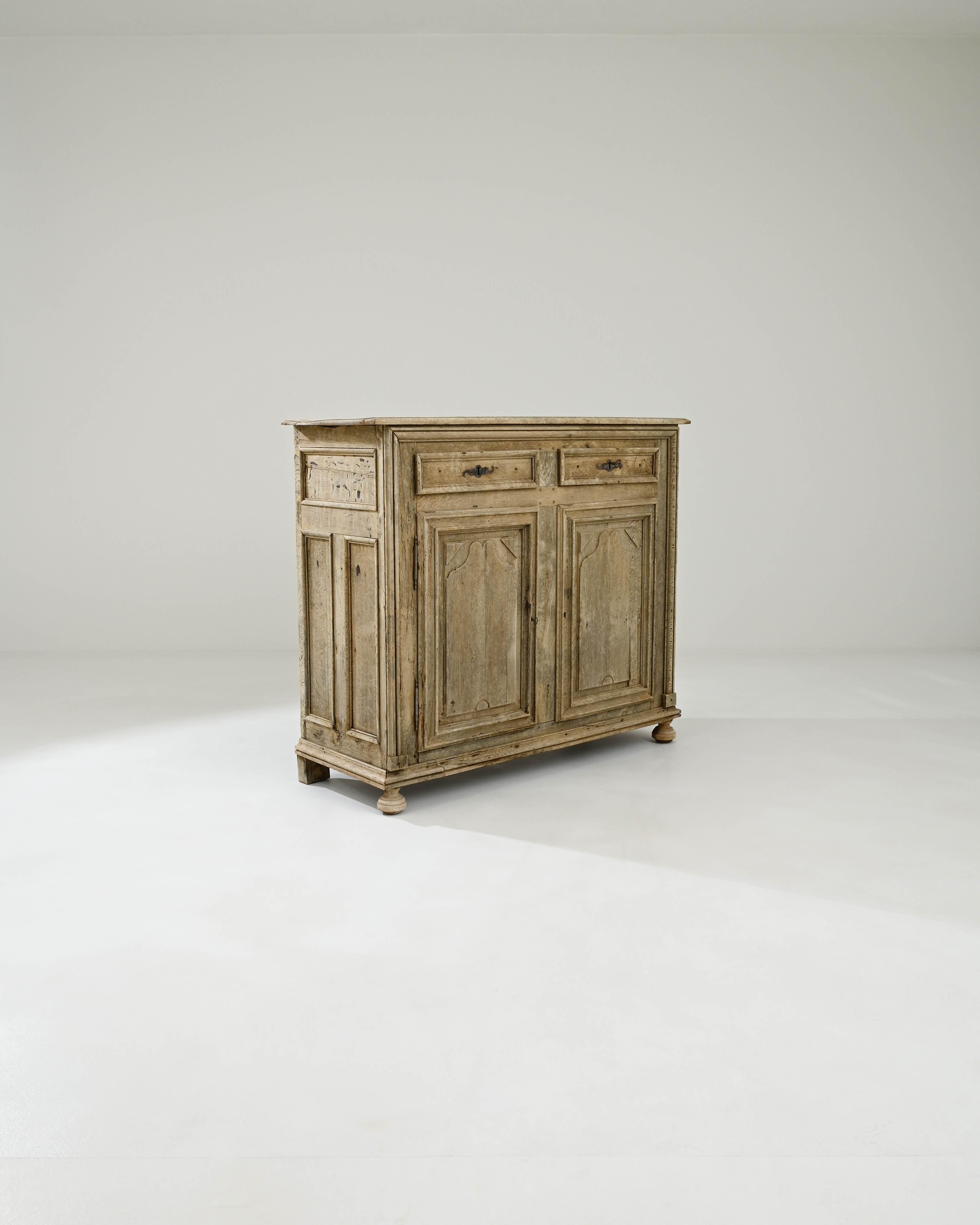 A wooden buffet created in 19th century France. Handsomely constructed and full of old-world crafty charm, this astute buffet offers a ray of regal light. The elaborately framed drawer paneling creates a succinct and geometrically pleasing