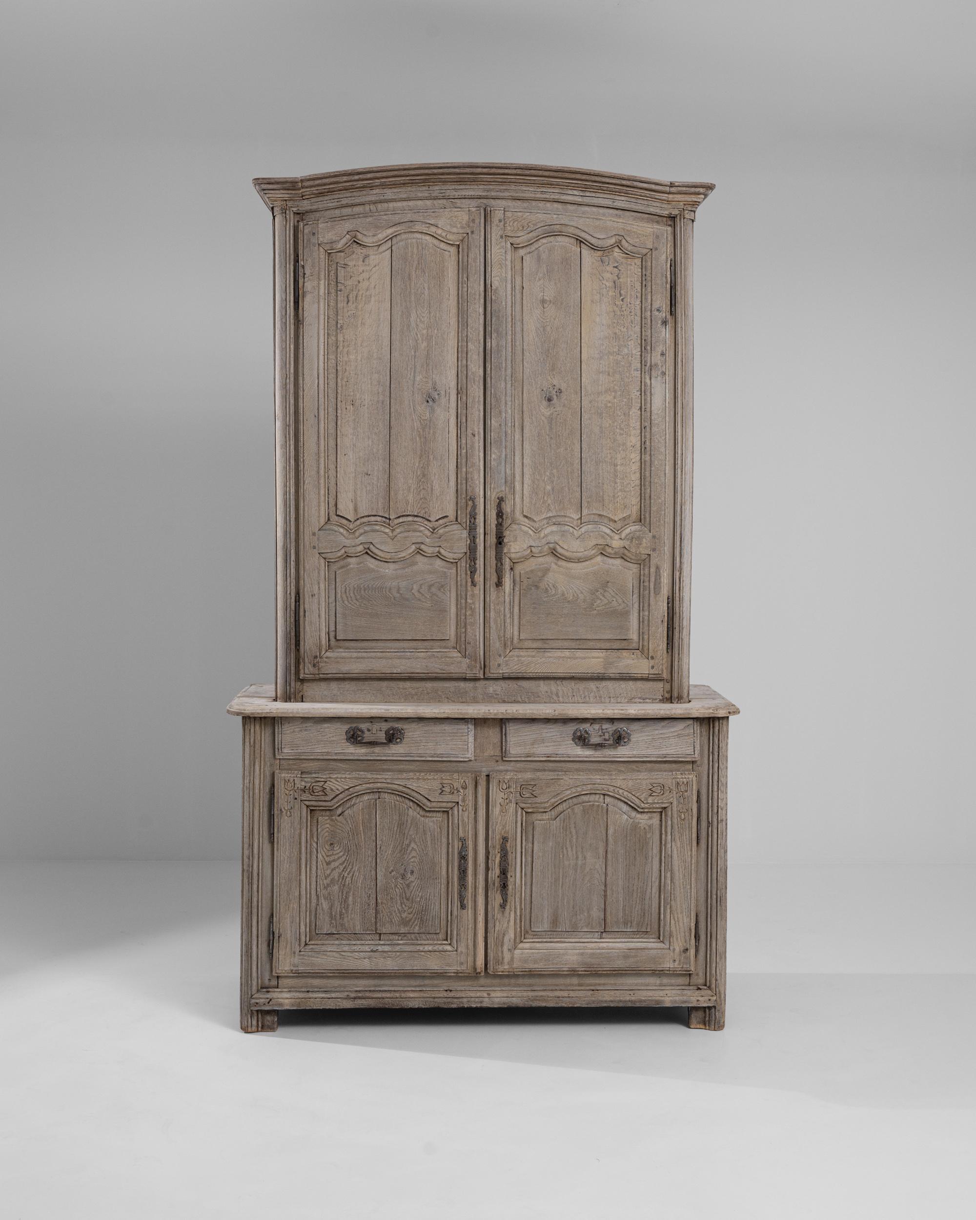 A wooden cabinet from 19th century France. This large cabinet is composed with plenty of storage, lots of shelves up and down, with two sliding drawers in between. Combining rustic charm with refined elegance, this artisanally crafted cabinet offers