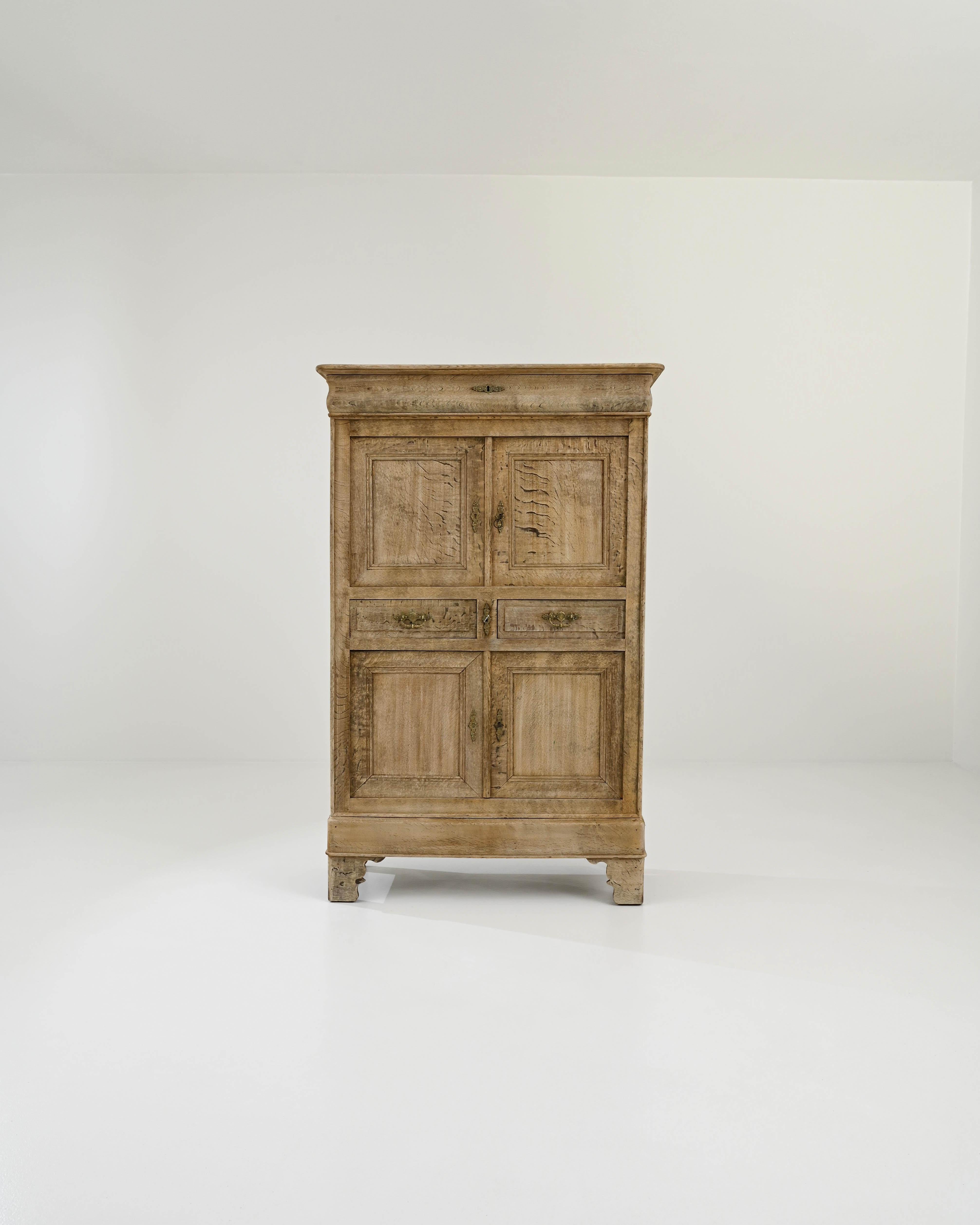 A wooden cabinet created in 19th century France. This tall sideboard cabinet opens its drawers in a welcoming expression. Elegant and traditional, the drawer panels, keyholes, and drawer pulls all have thoughtfully shaped curves and designs, which