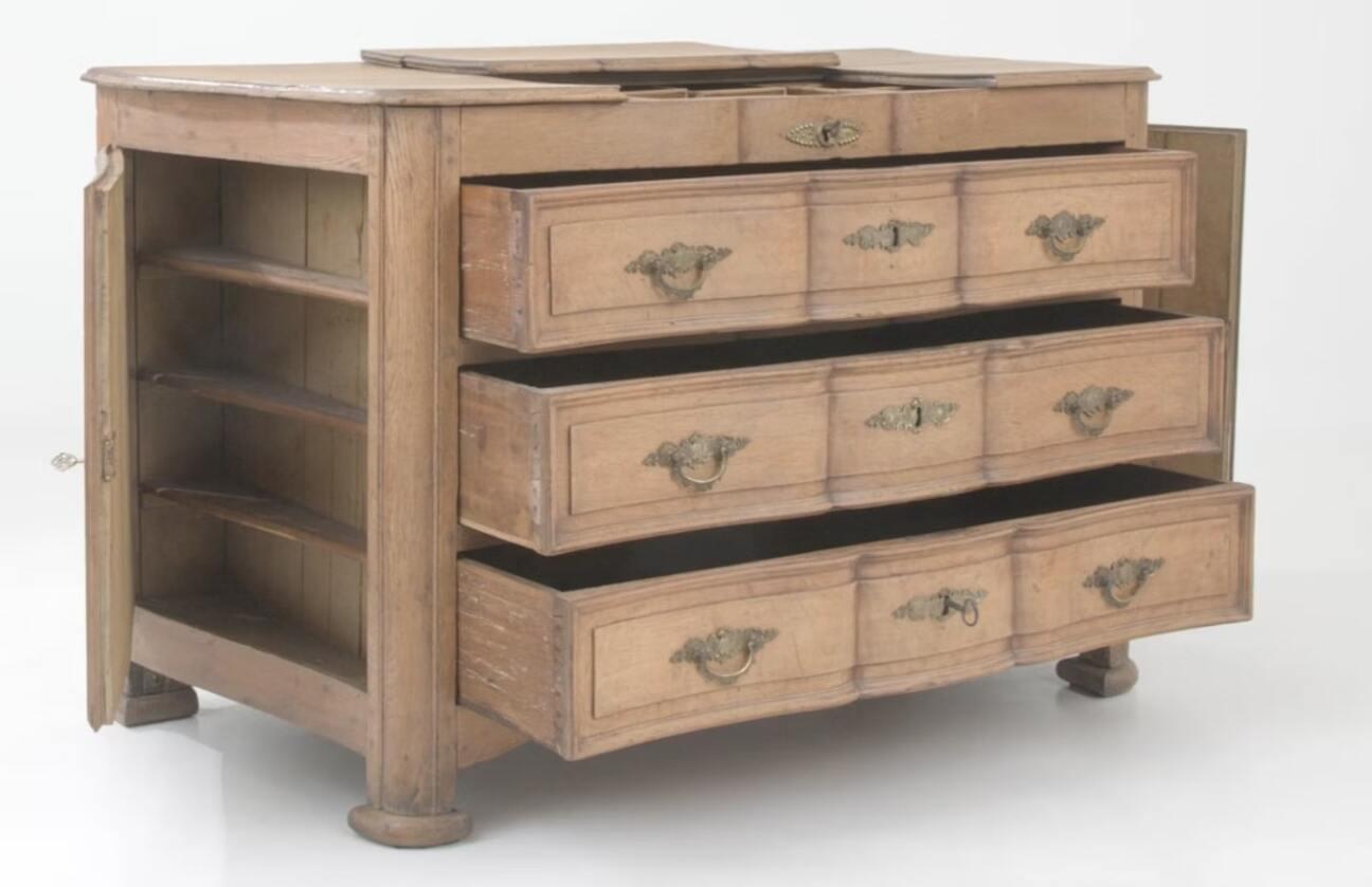 This elegant 19th-century French chest of drawers combines practicality with antique charm. Crafted from high-quality wood, the chest features three drawers in the front, each adorned with intricate brass pulls, adding a touch of sophistication. It