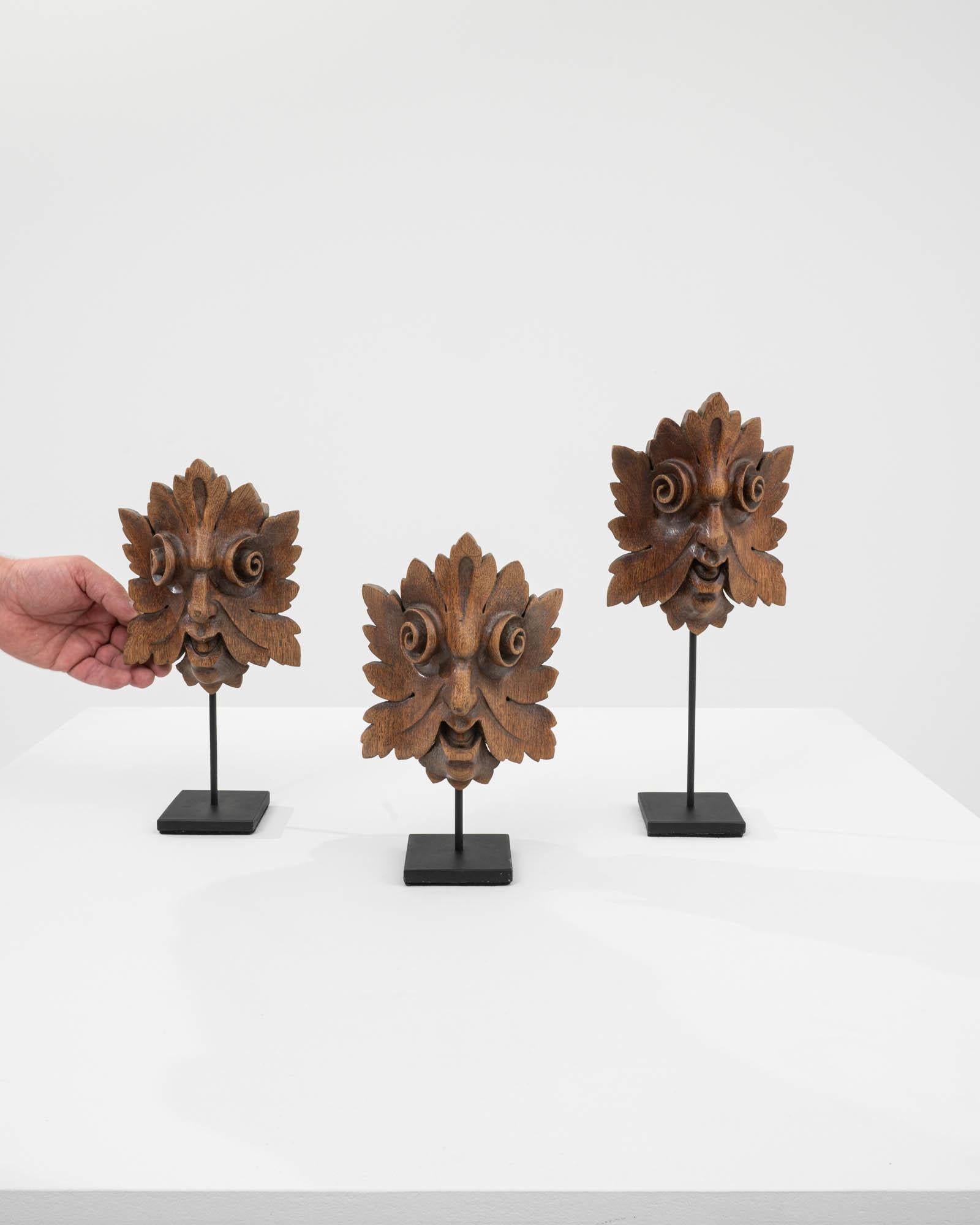 Immerse your space in the enchanting beauty of this set of 19th-century French wooden decorations on metal stands. Delicately crafted, each piece takes the form of a leaf, its intricate design breathing life into the wood. The wooden leaves boast