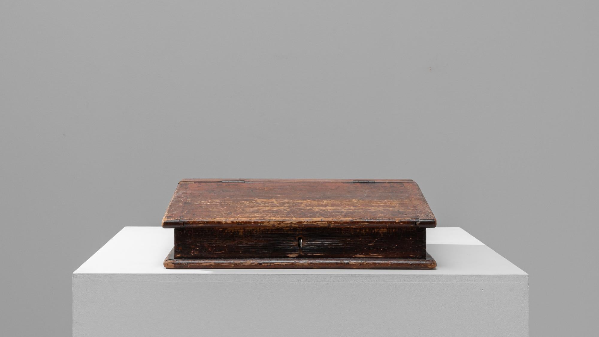 This 19th-century French wooden desk organizer is an artifact that exudes timeless elegance and rustic charm. Designed to provide a functional storage solution while adding a touch of vintage flair, this piece is crafted from durable wood,