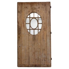 Puerta francesa de madera del siglo XIX con cristal geométrico ovalado