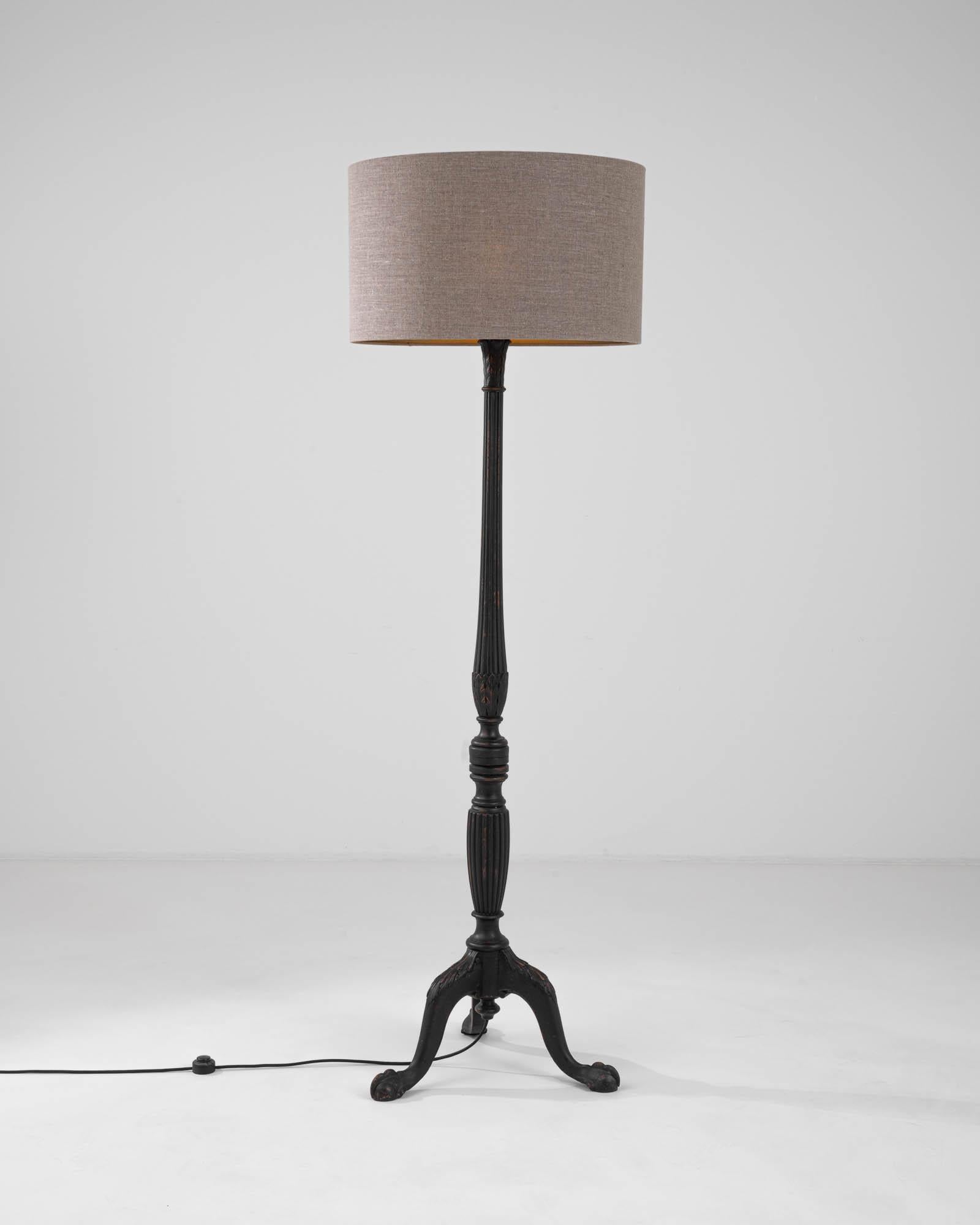 Introducing the 19th Century French Wooden Floor Lamp, a stunning embodiment of timeless design and elegance. The lamp's stand, with its intricately carved details, tells a tale of expert craftsmanship and classic beauty. A subtle yet dignified