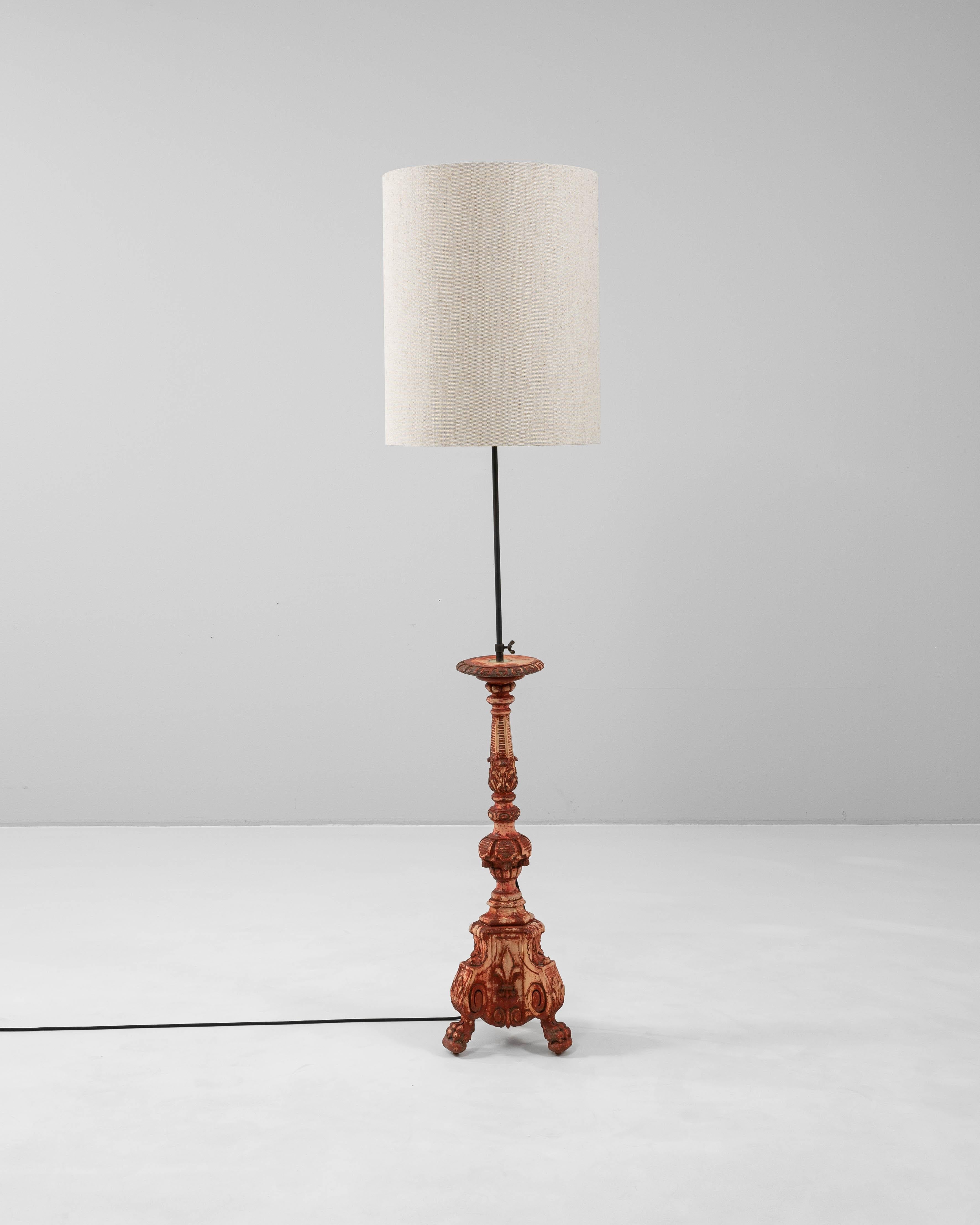 This 19th Century French wooden floor lamp showcases intricate craftsmanship and classical elegance. Originally a candlestick, the base features finely carved detailing with acanthus leaf motifs, scrollwork, and claw feet, reflecting the influence