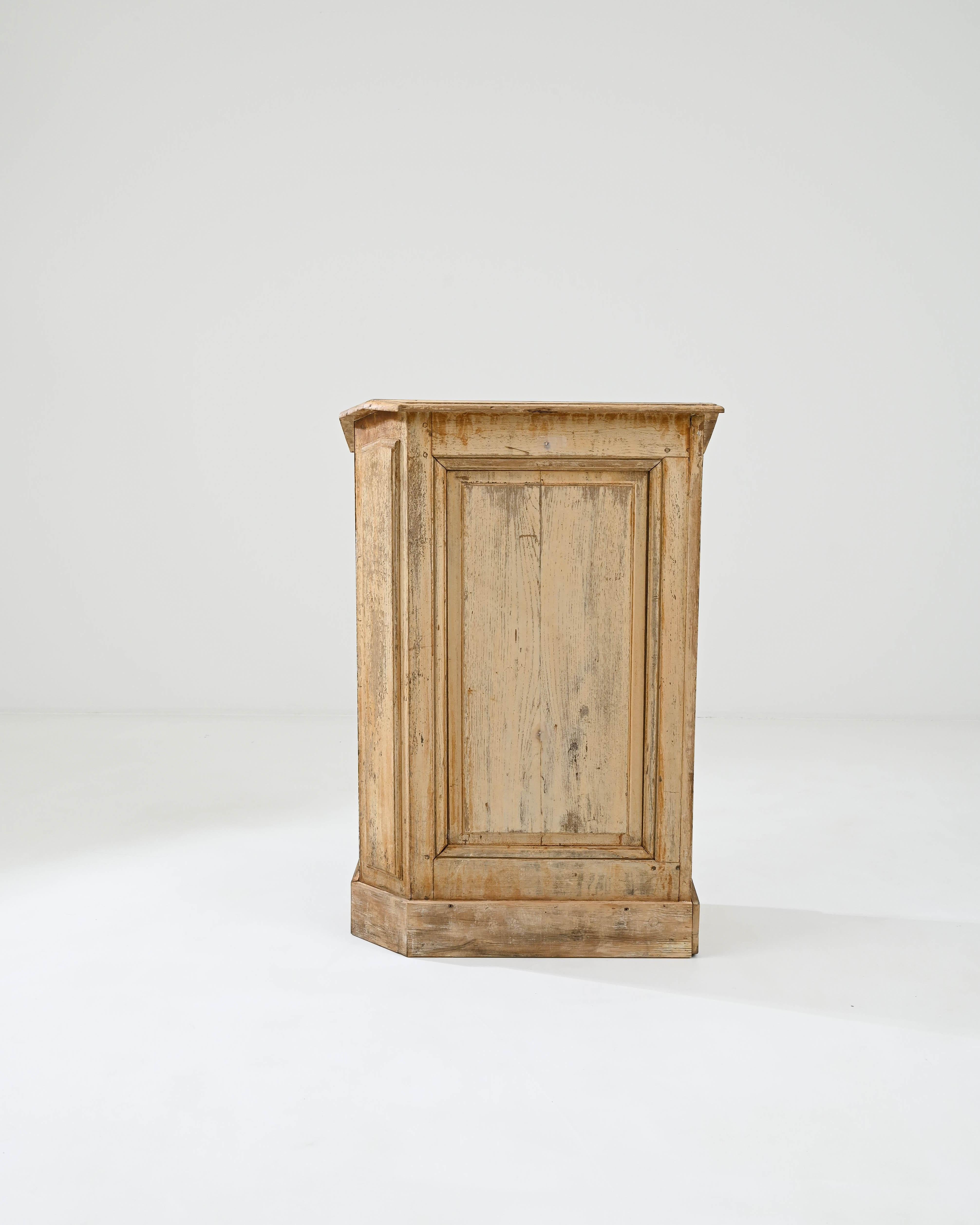 A pair of wooden lecterns created in 19th century France. Dramatically altered by time, these twin, symmetrical cabinets stand structurally intact, but wearing a patinated coat only achievable through time. Bright and airy, yet matured and full of